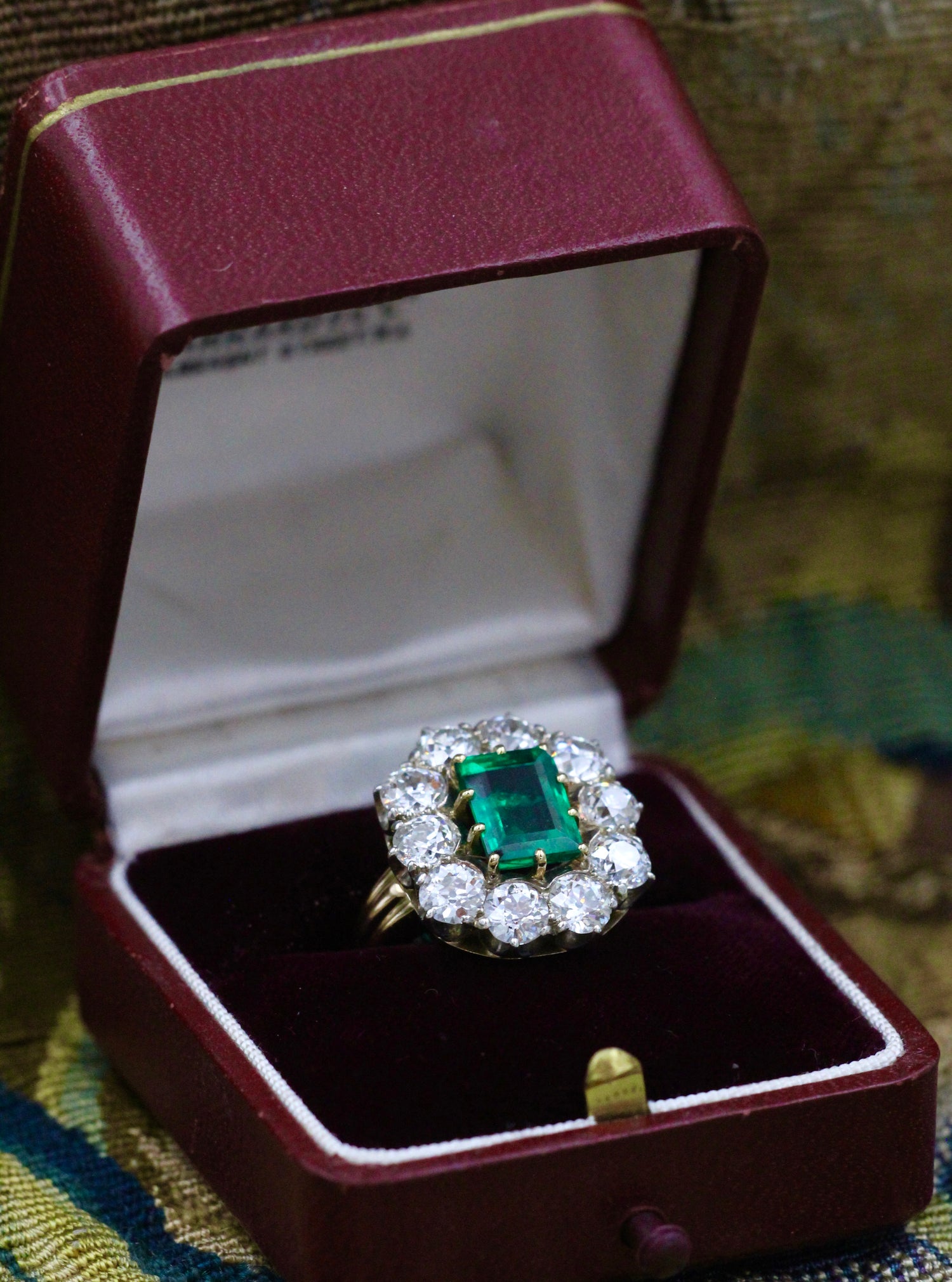 An exceptional Emerald and Diamond Cluster Ring. Colombian Emerald, 2.60 carats approximately, minor oil, with ten Old Cut Diamonds, approximately 4.00 carats (unweighed).  Ring circa 1890. - Robin Haydock Antiques