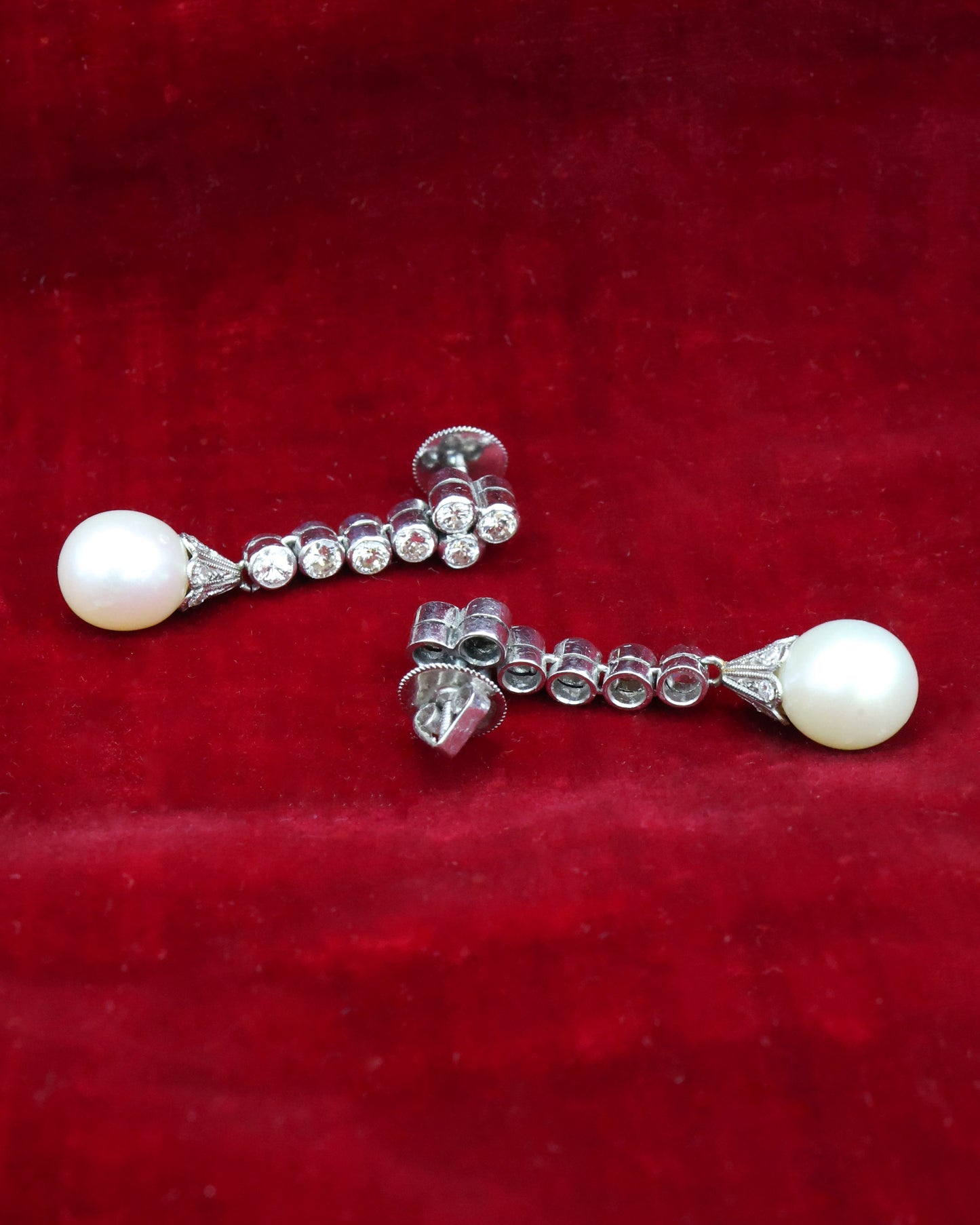 A fine pair of Platinum, Cultured Pearl & Diamond Drop Earrings. Circa 1950