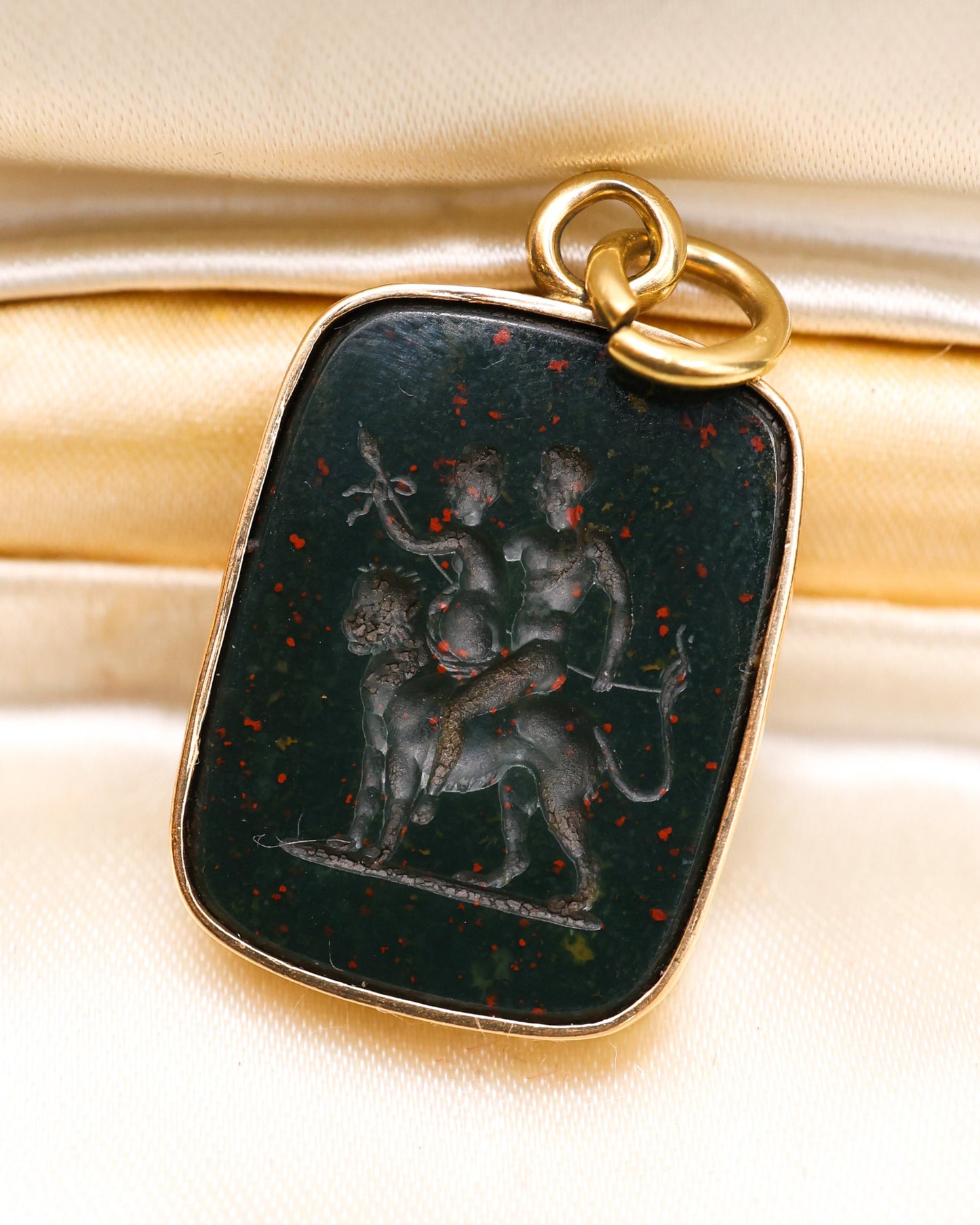 A very fine mid-18th Century, Bloodstone Erotic Intaglio, in a later 9ct English Yellow Gold Pendant Frame with articulated bail. Intaglio probably Italian, Circa 1750.