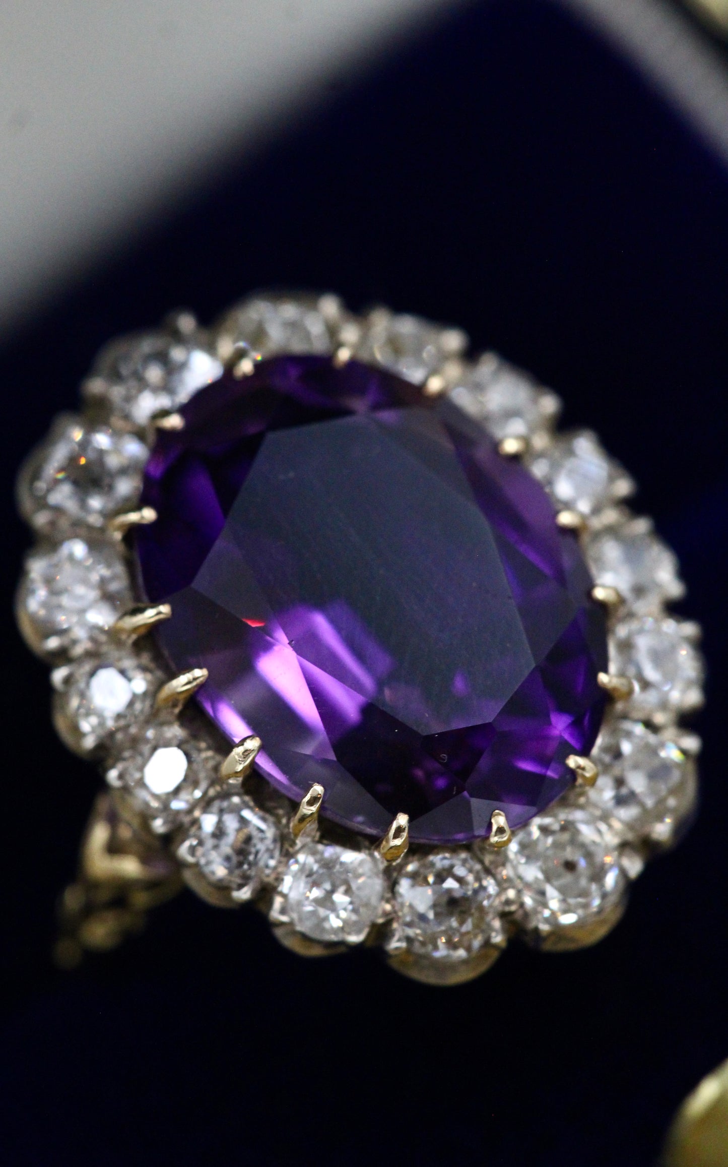 An Amethyst and Diamond Cluster Ring set with an Oval Amethyst, surrounded by 2.00 Carats of "Old Mine" Cut (Cushion), Shaped Diamonds, mounted in Silver on Gold, stamped 18 ct. Circa 1900. - Robin Haydock Antiques