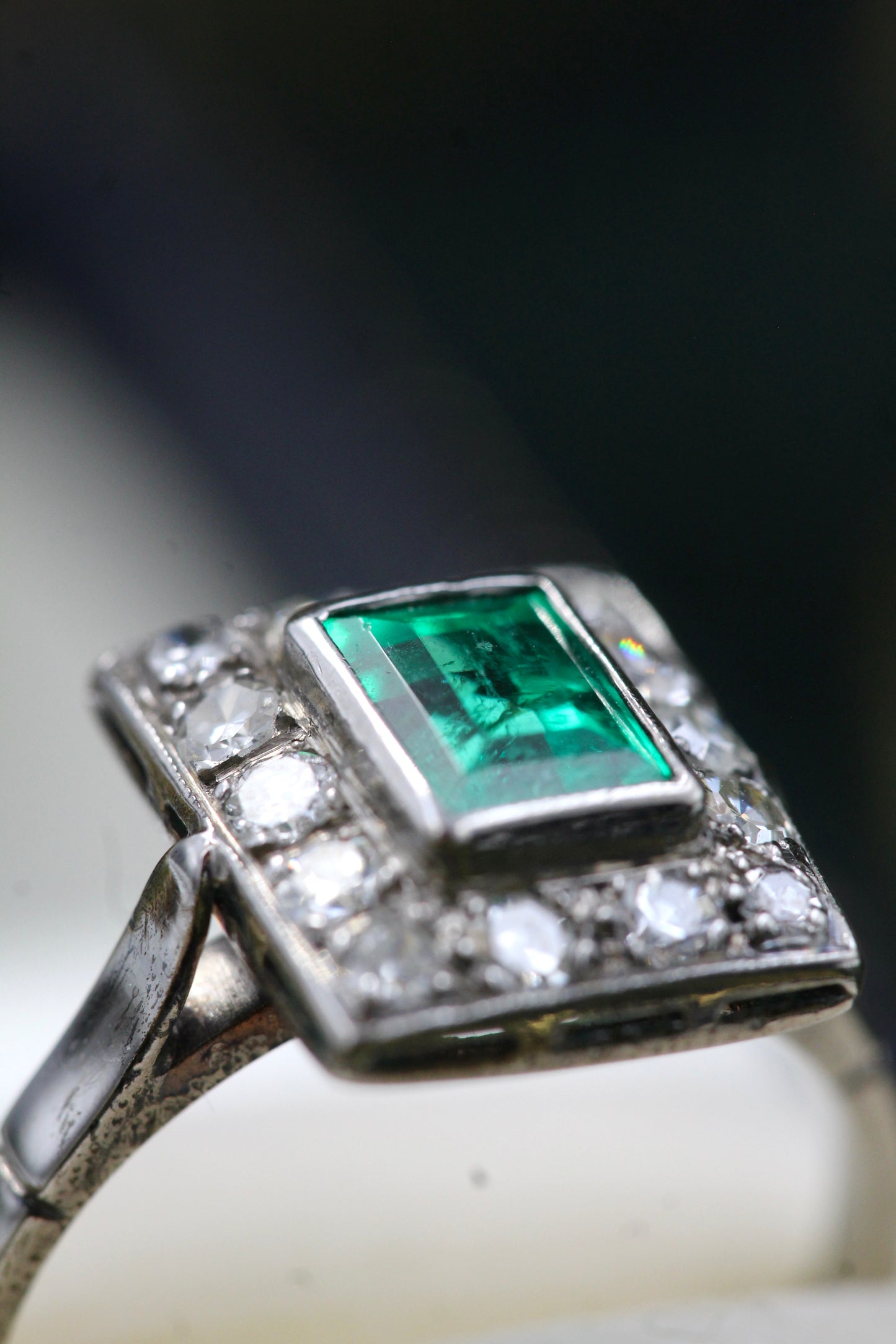 A very fine Platinum (tested) Cluster Ring set with a Modified Step Cut Emerald Certified as 1.10 carats "Colombian" (Moderate Oil), surrounded by gallery of fourteen Single Cut Diamonds. Circa 1930 - Robin Haydock Antiques