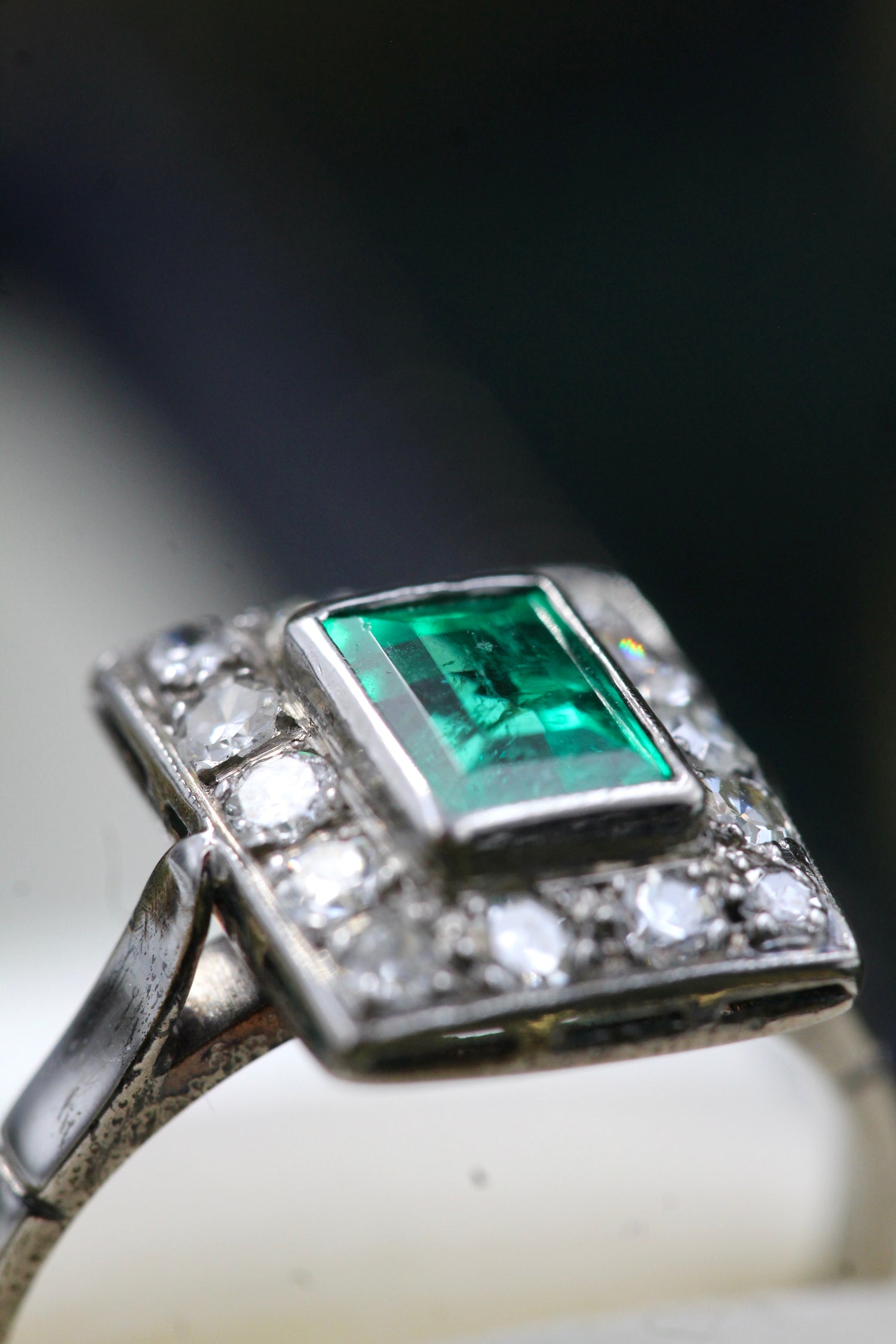 A very fine Platinum (tested) Cluster Ring set with a Modified Step Cut Emerald Certified as 1.10 carats "Colombian" (Moderate Oil), surrounded by gallery of fourteen Single Cut Diamonds. Circa 1930 - Robin Haydock Antiques