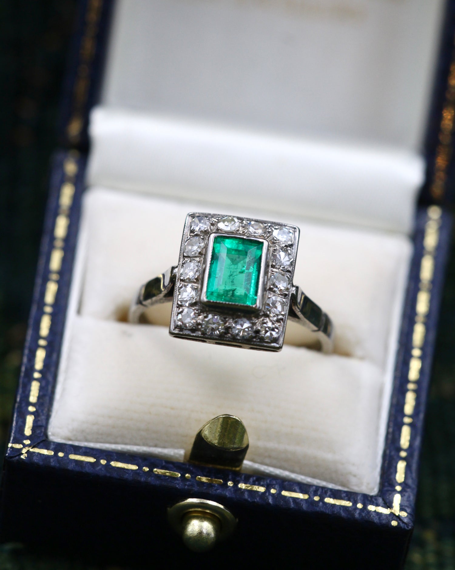 A very fine Platinum (tested) Cluster Ring set with a Modified Step Cut Emerald Certified as 1.10 carats "Colombian" (Moderate Oil), surrounded by gallery of fourteen Single Cut Diamonds. Circa 1930 - Robin Haydock Antiques
