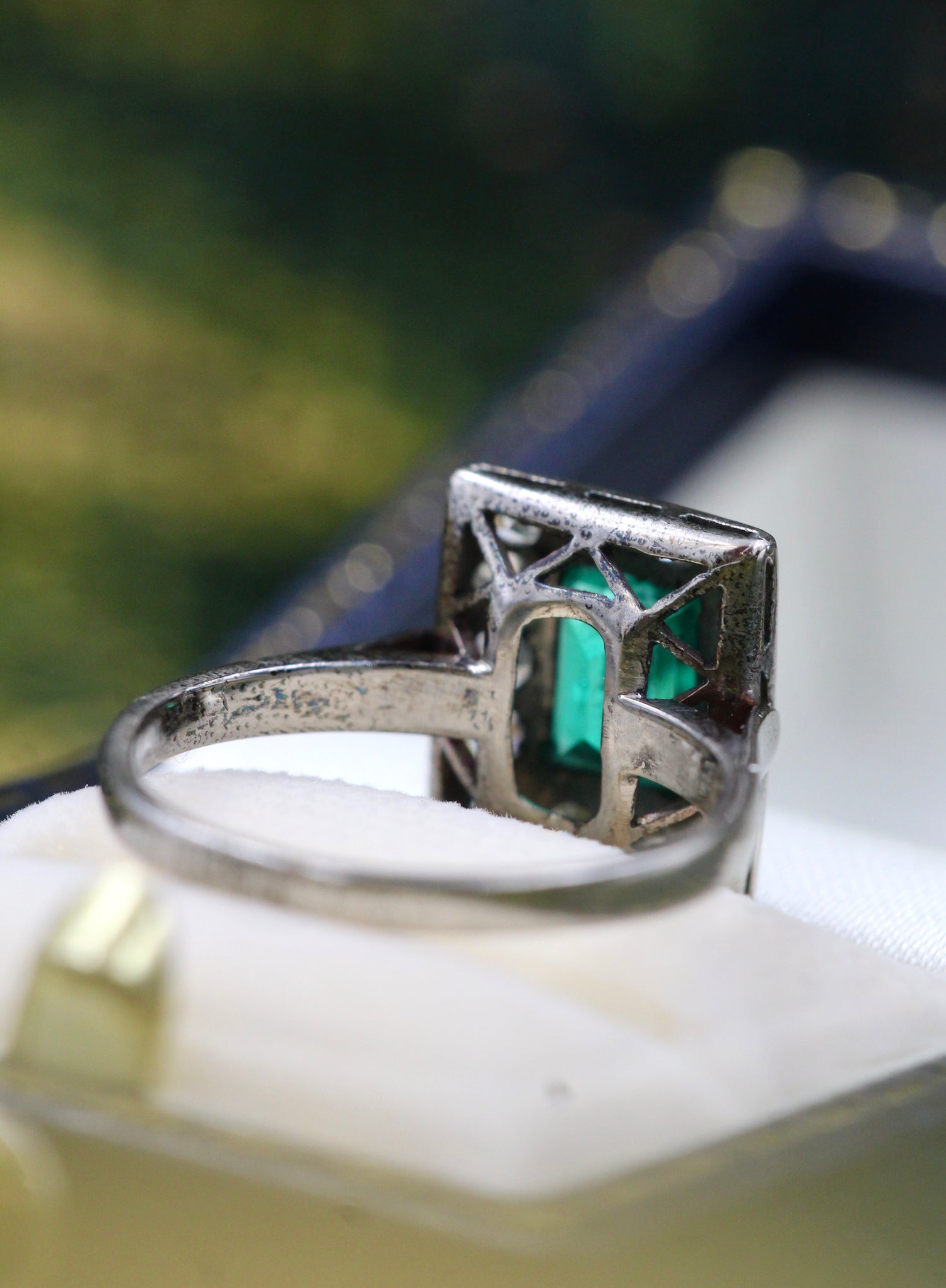 A very fine Platinum (tested) Cluster Ring set with a Modified Step Cut Emerald Certified as 1.10 carats "Colombian" (Moderate Oil), surrounded by gallery of fourteen Single Cut Diamonds. Circa 1930 - Robin Haydock Antiques
