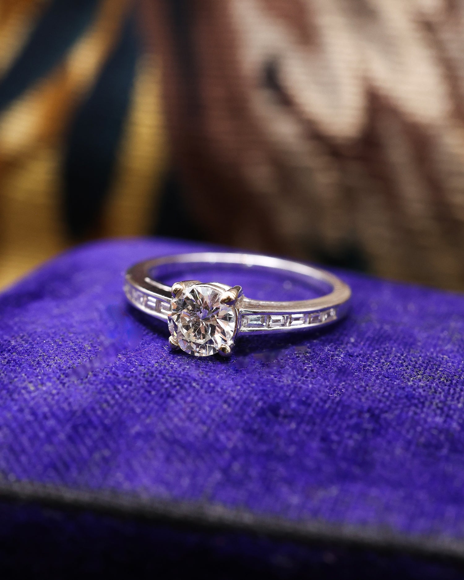 A very fine 18 ct White Gold Diamond  Solitaire Ring, 0.66 Carats Approximately, with shoulder settings of 0.18 Carats (stamped) of Modified Step Cut Diamonds.  Preowned - Robin Haydock Antique Jewellery
