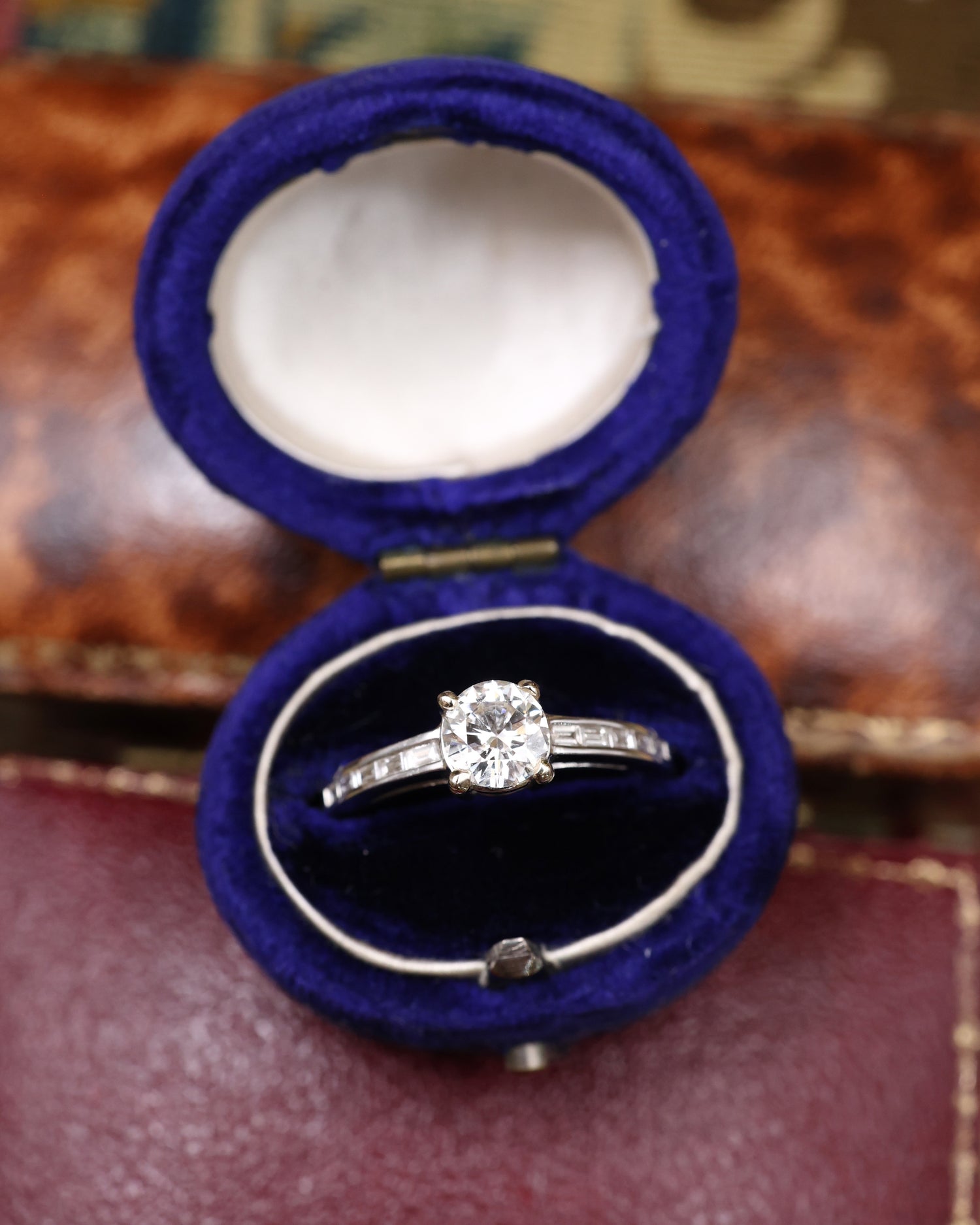 A very fine 18 ct White Gold Diamond  Solitaire Ring, 0.66 Carats Approximately, with shoulder settings of 0.18 Carats (stamped) of Modified Step Cut Diamonds.  Preowned - Robin Haydock Antique Jewellery