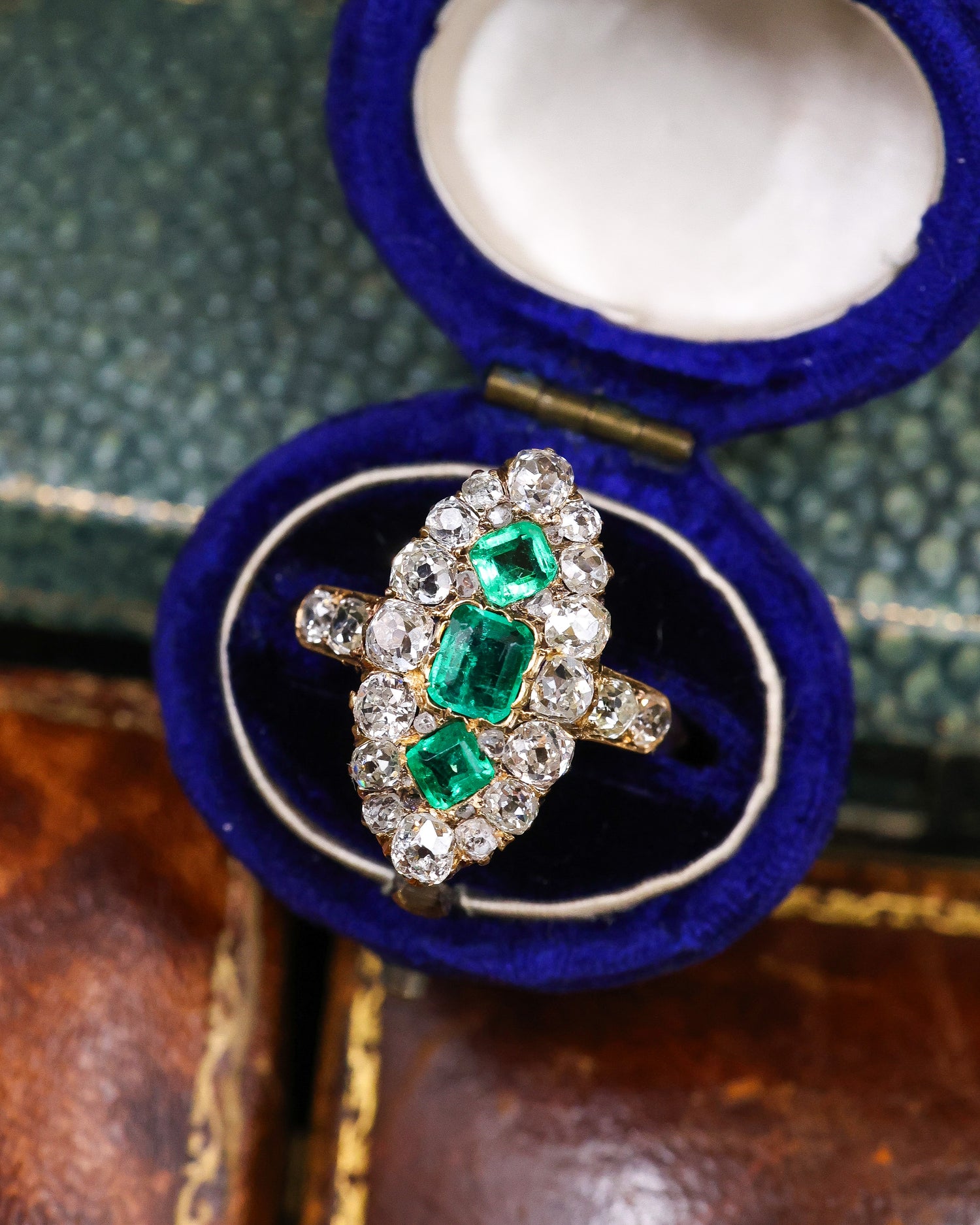 A very fine antique 18 ct. Yellow Gold (tested),  Navette shaped ring set with three Octagonal Step Cut Natural Emeralds & numerous Diamonds, with Diamond set shoulders. English. Circa 1870. - Robin Haydock Antique Jewellery