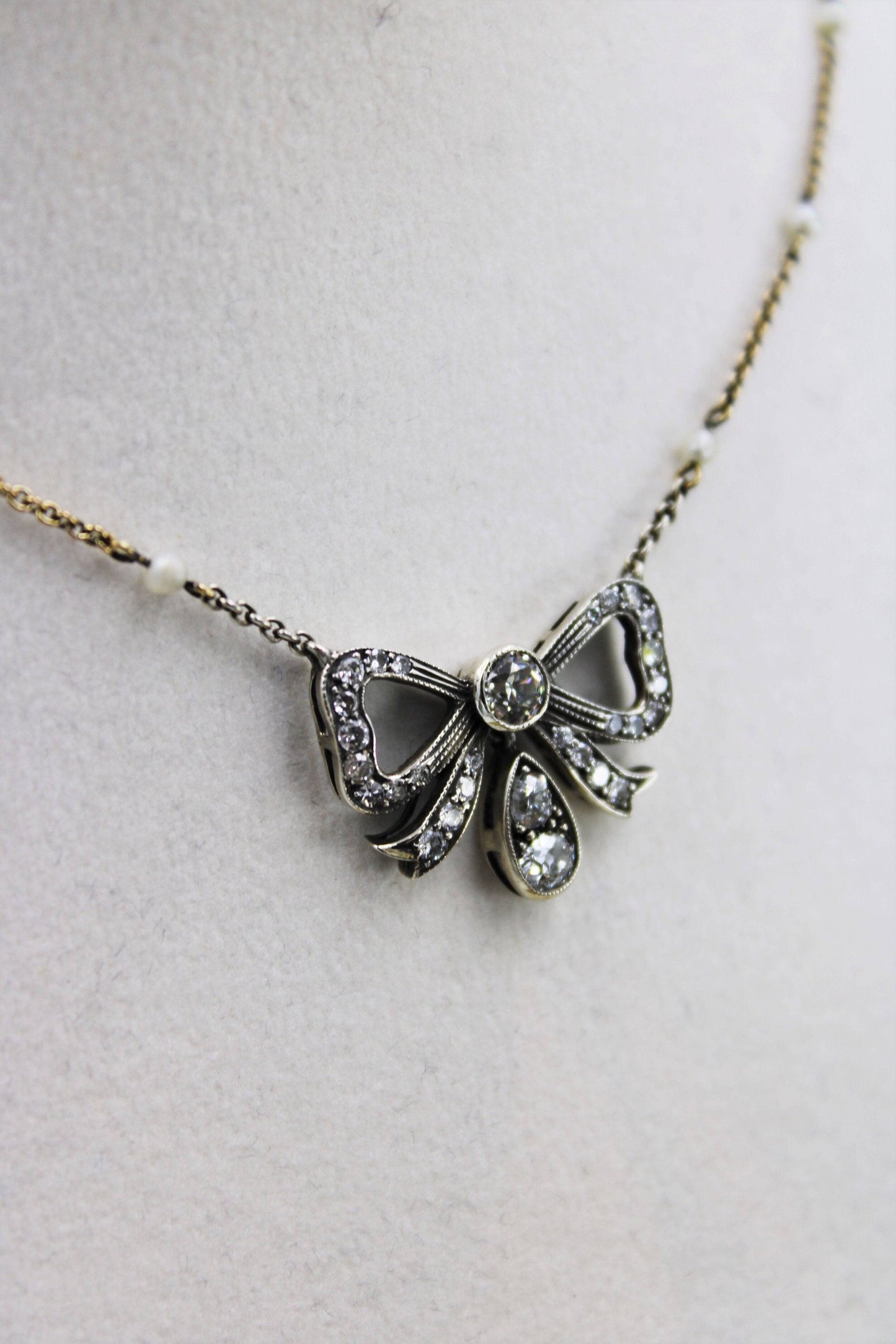 A very fine Victorian Diamond Bow Pendant mounted in Silver and High Carat Yellow Gold, English, Circa 1890 - Robin Haydock Antiques