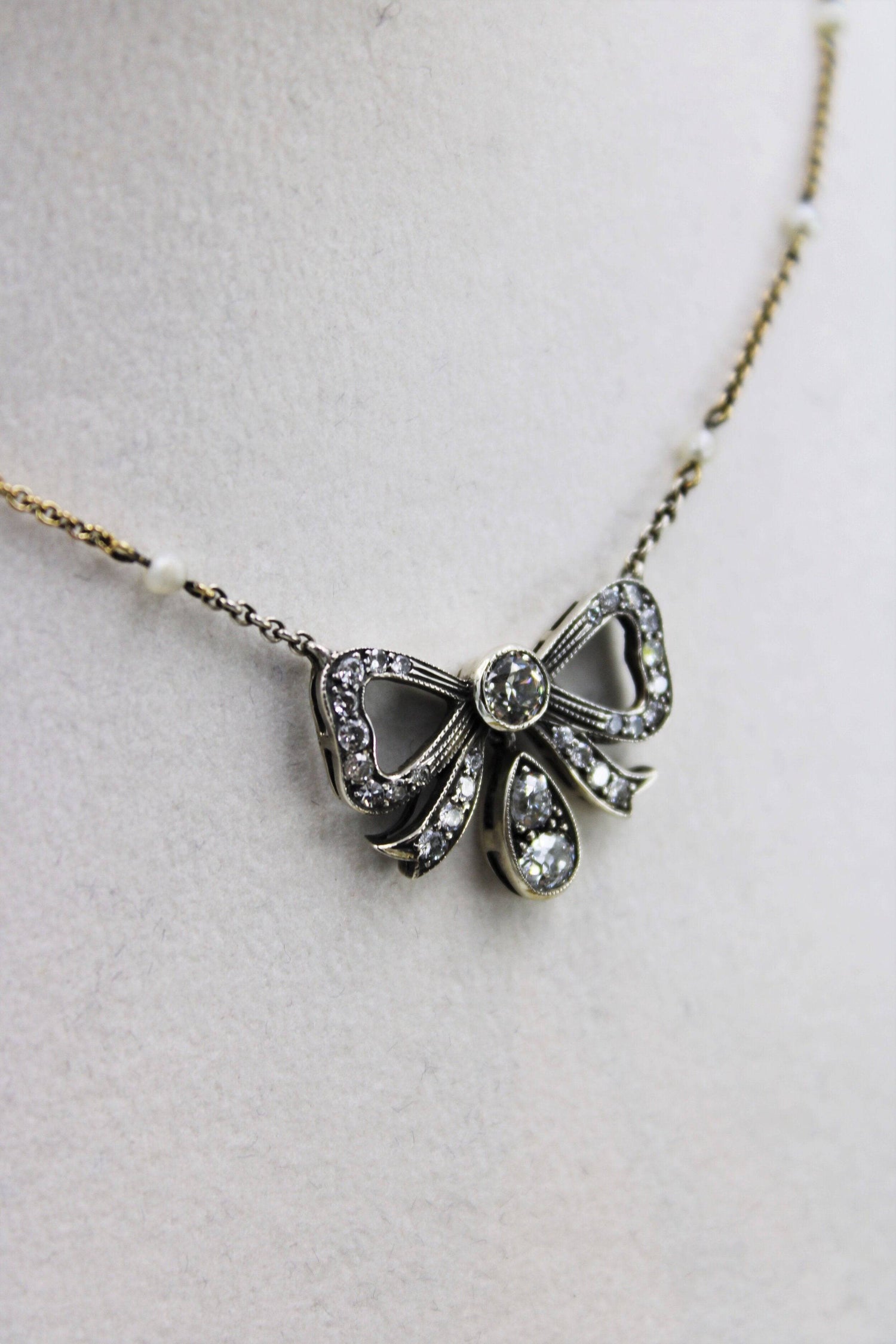 A very fine Victorian Diamond Bow Pendant mounted in Silver and High Carat Yellow Gold, English, Circa 1890 - Robin Haydock Antiques