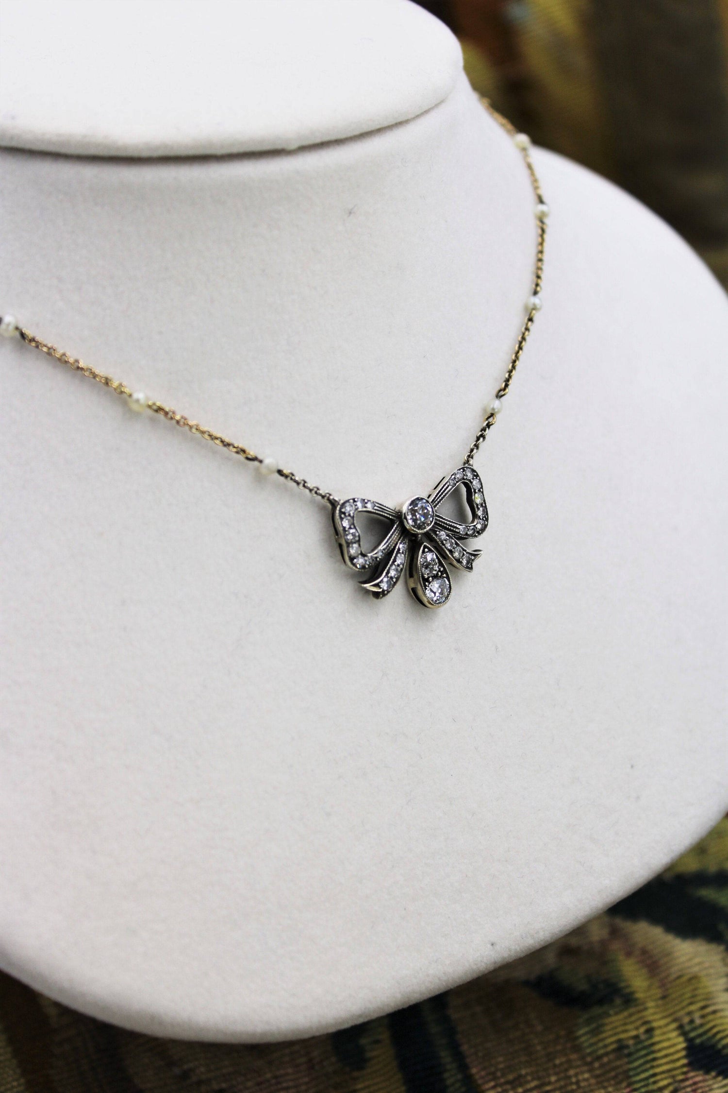 A very fine Victorian Diamond Bow Pendant mounted in Silver and High Carat Yellow Gold, English, Circa 1890 - Robin Haydock Antiques