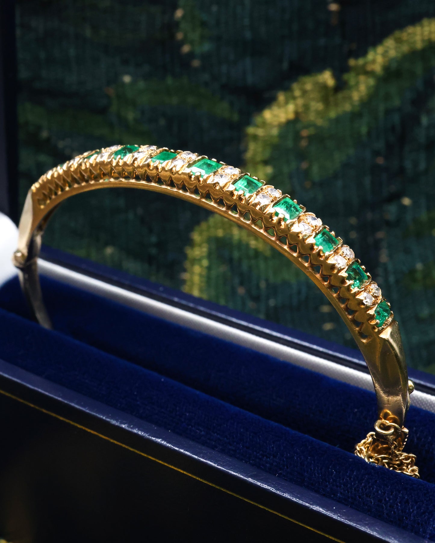 A very fine 15 ct Yellow Gold (tested), 2.20 Carat Colombian Emerald & Diamond Half Hinged Bangle. English Circa 1900.