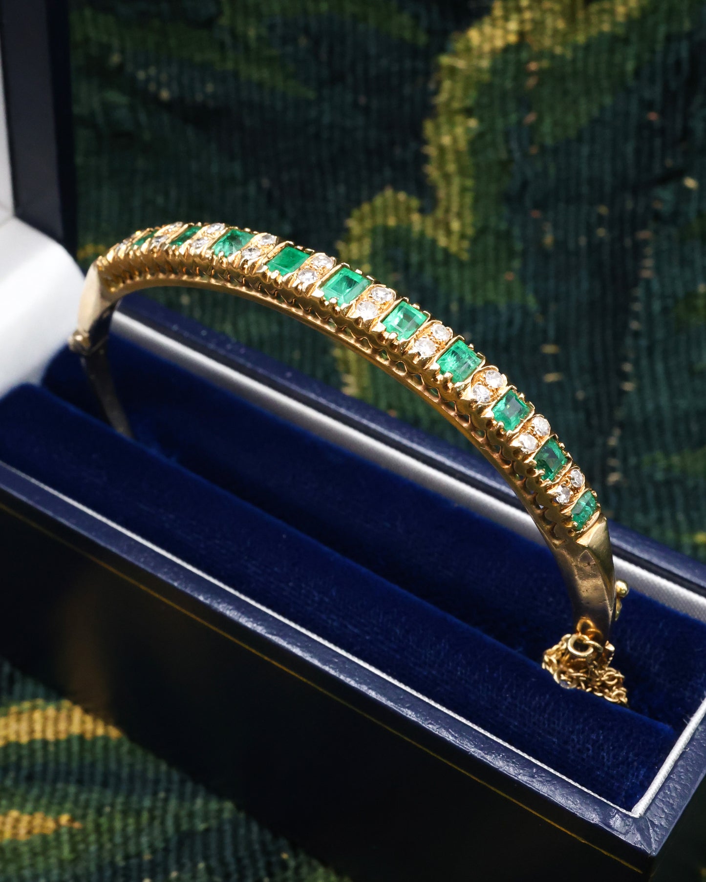A very fine 15 ct Yellow Gold (tested), 2.20 Carat Colombian Emerald & Diamond Half Hinged Bangle. English Circa 1900.