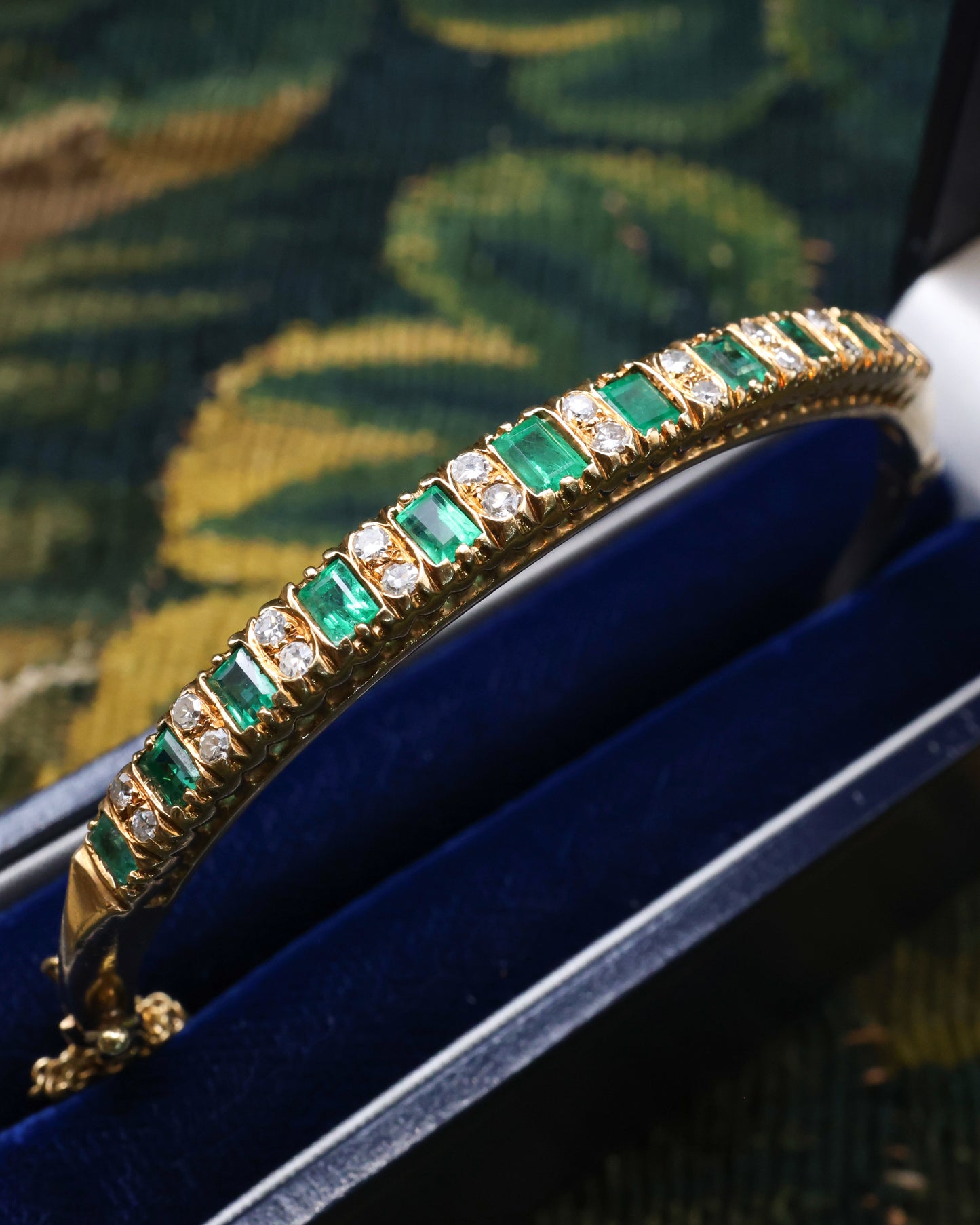 A very fine 15 ct Yellow Gold (tested), 2.20 Carat Colombian Emerald & Diamond Half Hinged Bangle. English Circa 1900.