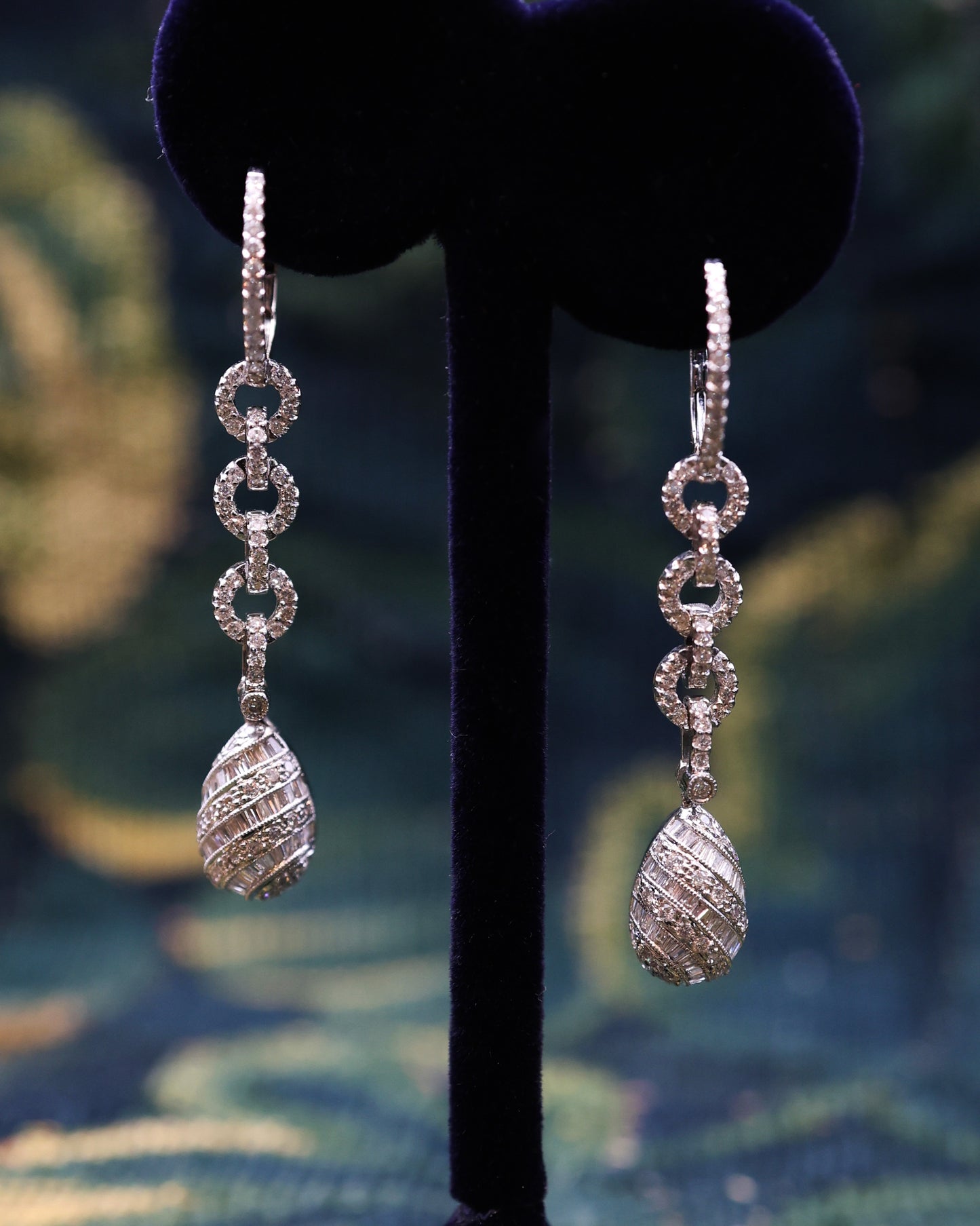 A fine pair of 18ct White Gold (marked), Round Brilliant & Emerald Cut Diamond Drop Earrings. approximately 1.35 Carats (unweighed). Pre-owned.