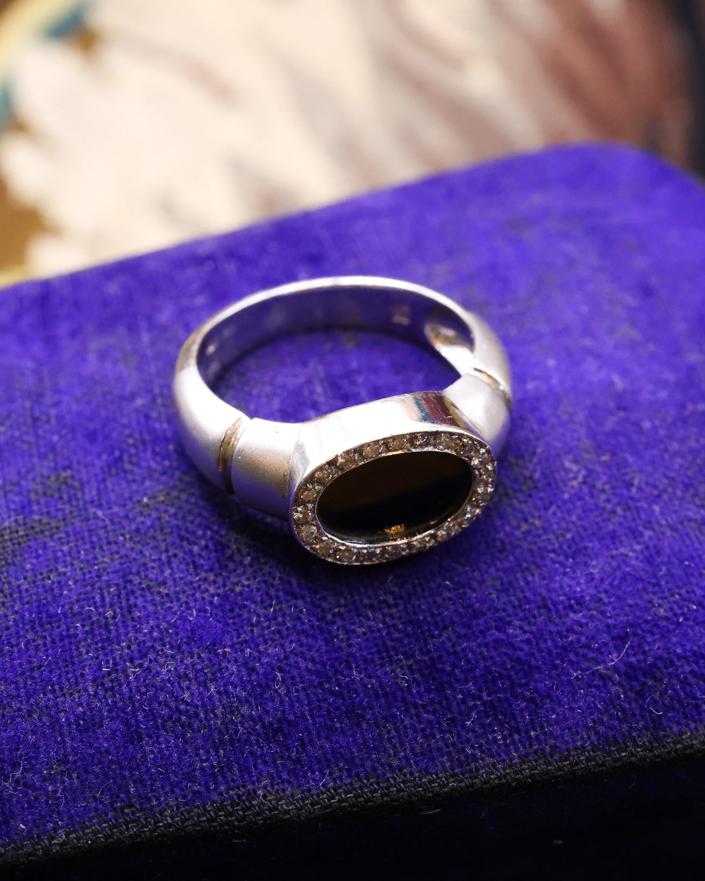 An 18ct (marked) Brushed White Gold Plaque Ring, with Oval Black Onyx, surrounded by a gallery of Single Cut Diamonds. Circa 1970 - Robin Haydock Antique Jewellery