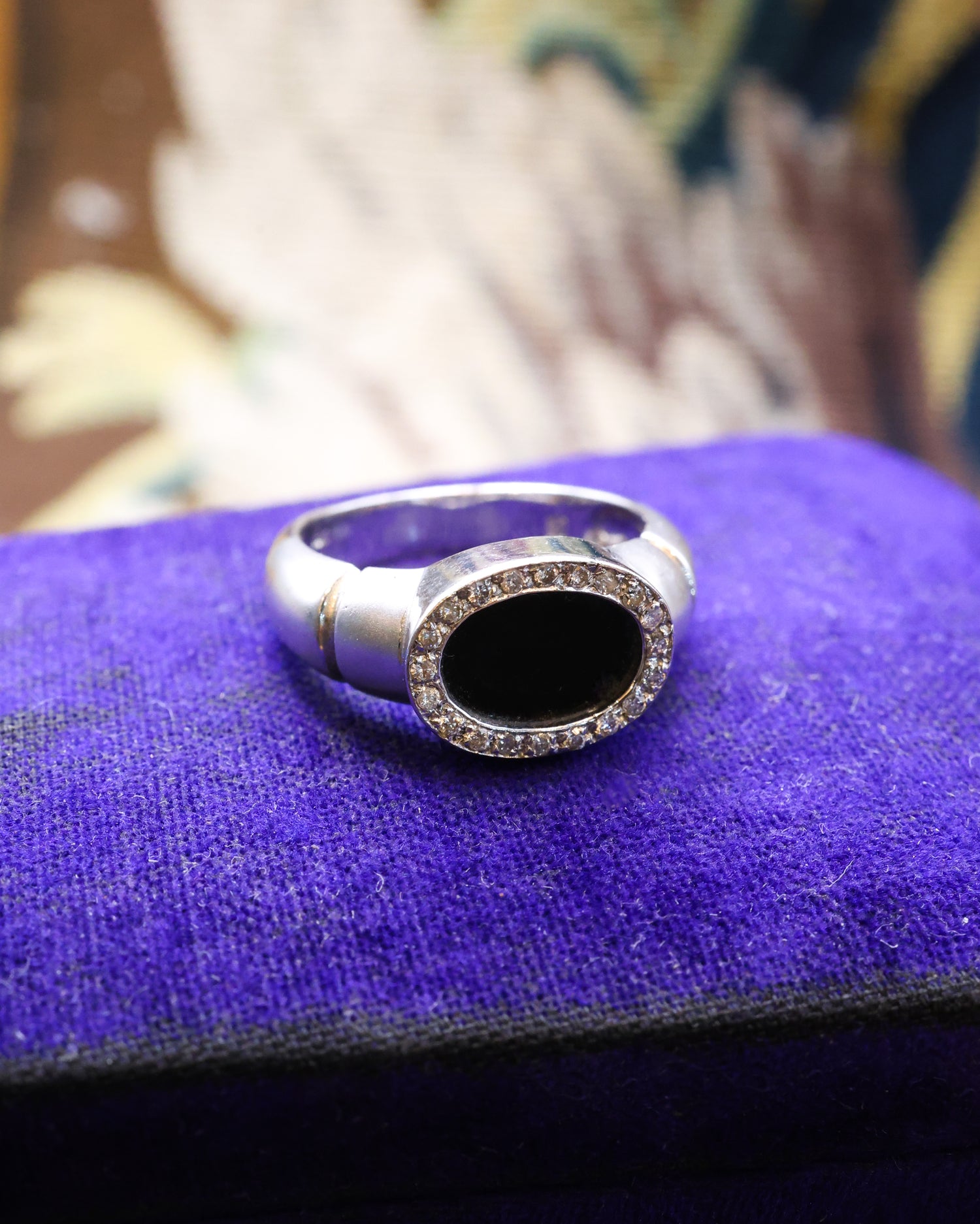 An 18ct (marked) Brushed White Gold Plaque Ring, with Oval Black Onyx, surrounded by a gallery of Single Cut Diamonds. Circa 1970 - Robin Haydock Antique Jewellery