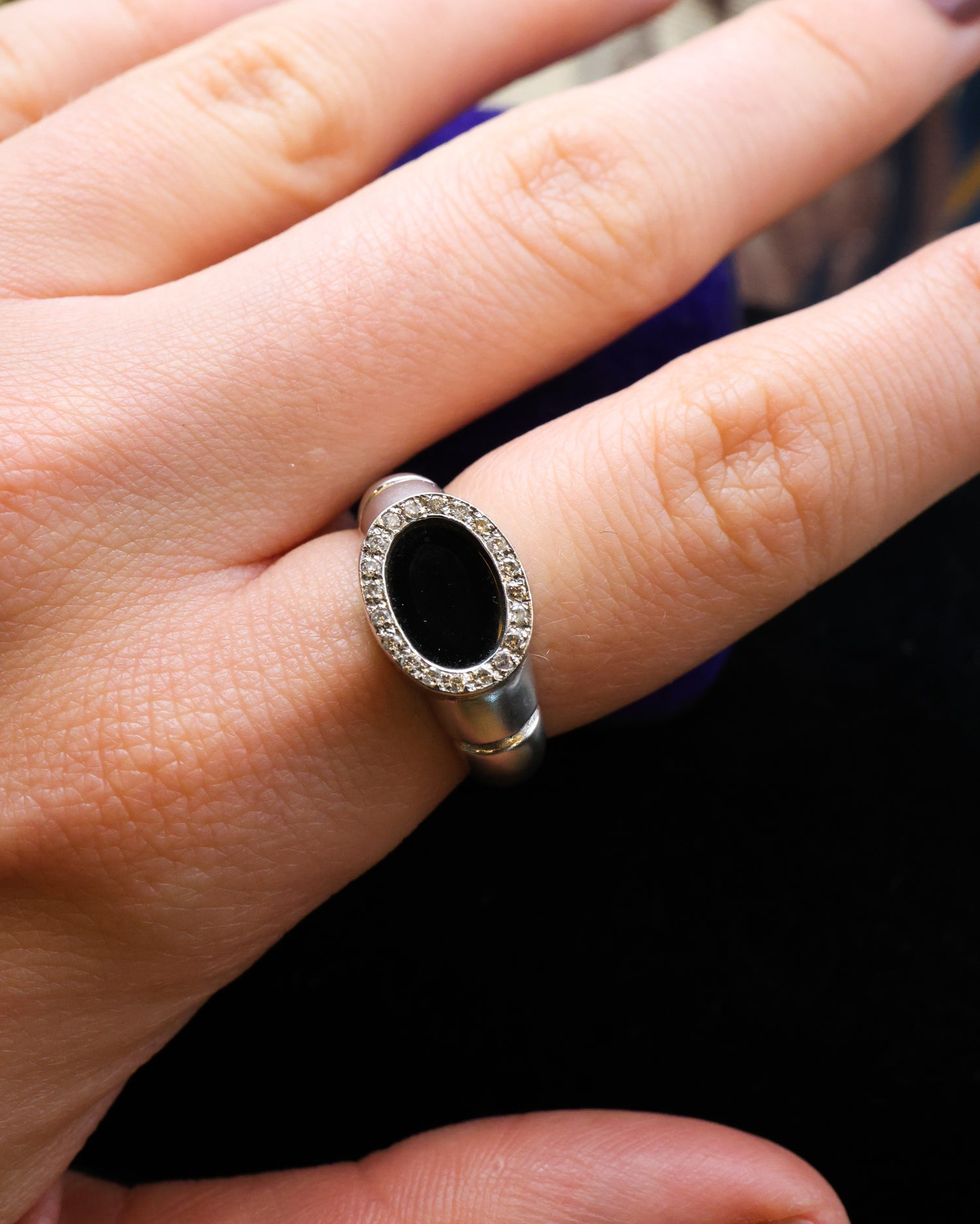 An 18ct (marked) Brushed White Gold Plaque Ring, with Oval Black Onyx, surrounded by a gallery of Single Cut Diamonds. Circa 1970 - Robin Haydock Antique Jewellery