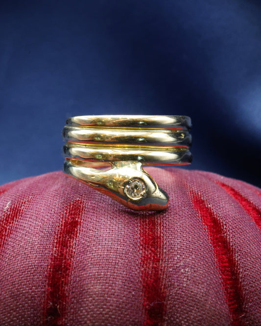 A very fine 18 Carat Yellow Gold (tested),Triple Coil Snake Ring, with an old cut Diamond of approximately 0.27 Carats, Circa 1910