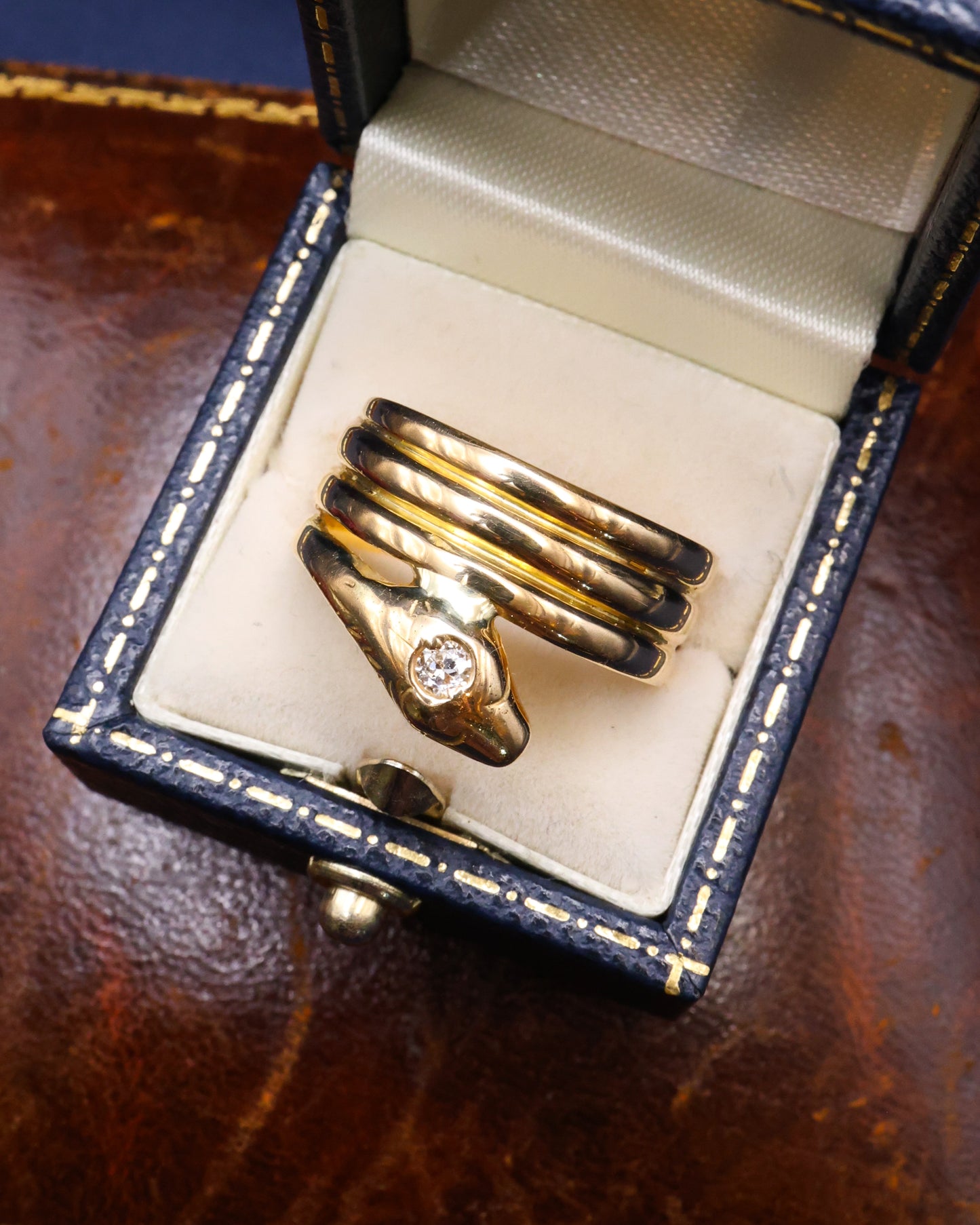 A very fine 18 Carat Yellow Gold (tested),Triple Coil Snake Ring, with an old cut Diamond of approximately 0.27 Carats, Circa 1910