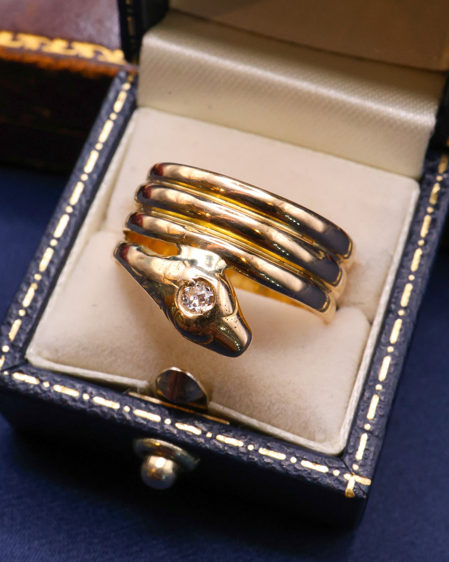 A very fine 18 Carat Yellow Gold (tested),Triple Coil Snake Ring, with an old cut Diamond of approximately 0.27 Carats, Circa 1910