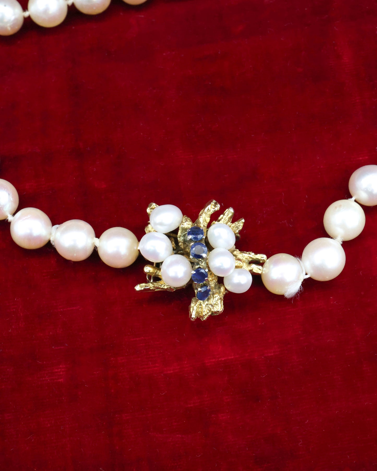 A fine Yellow Gold & Strung Cultured Pearl Necklace, set with four Round Cut Natural Sapphires (0.40 carats) and eighty three Oval and Near Shaped Cultured Pearls. Circa 1960
