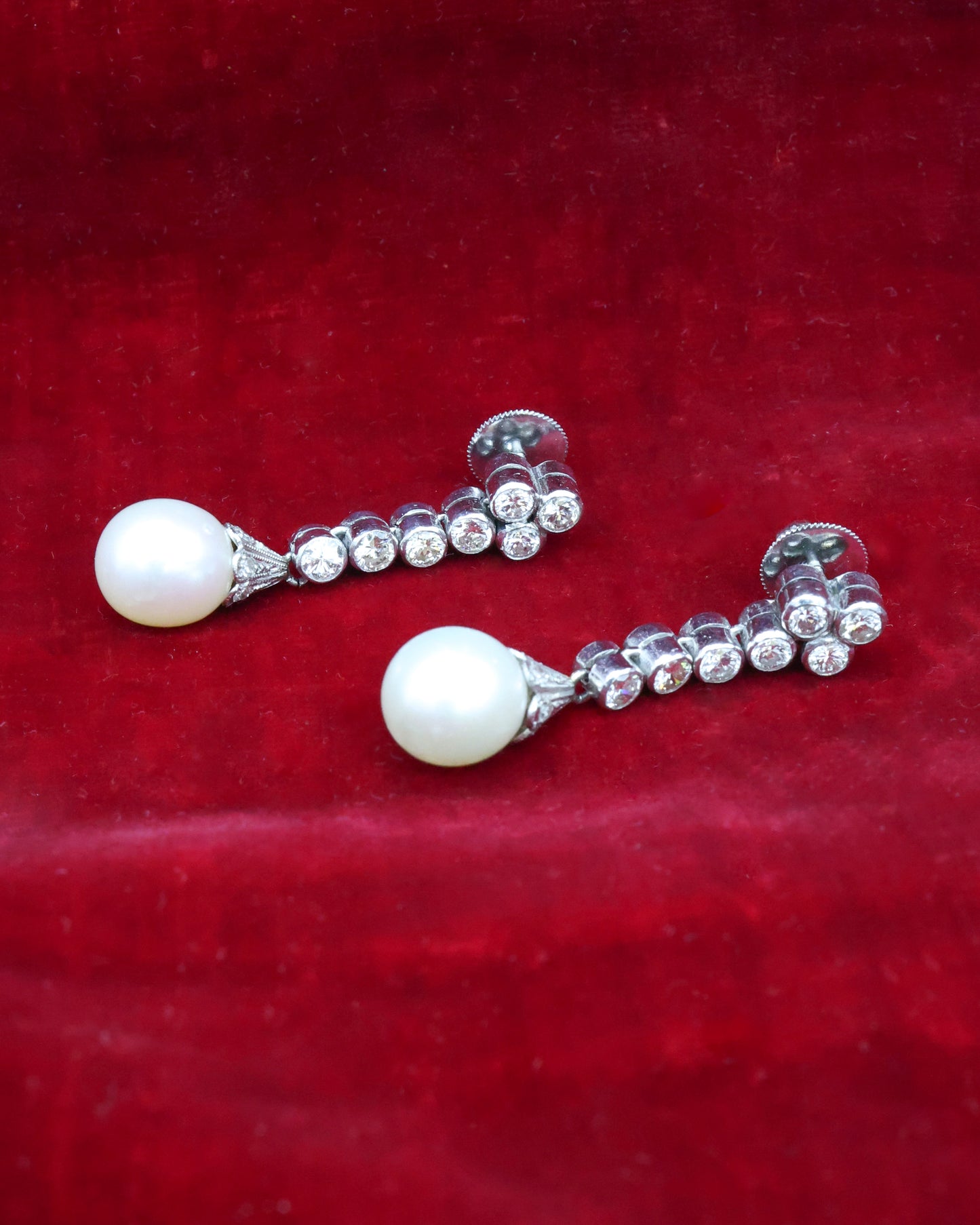 A fine pair of Platinum, Cultured Pearl & Diamond Drop Earrings. Circa 1950