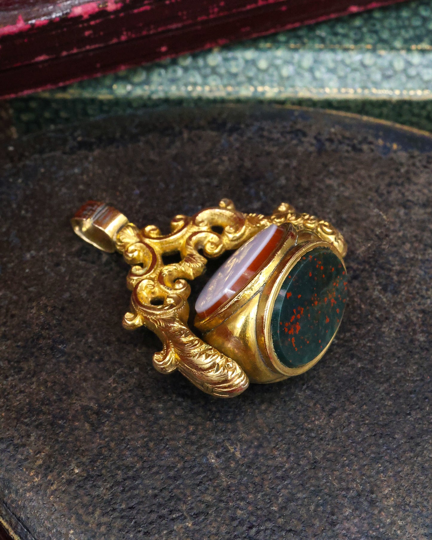 A late Georgian Pinchbeck, revolving, triple Seal, set with three oval (unmarked), Hardstones: Bloodstone, Carnelian & Carnelian with Viterous Lustre.  Circa. 1820