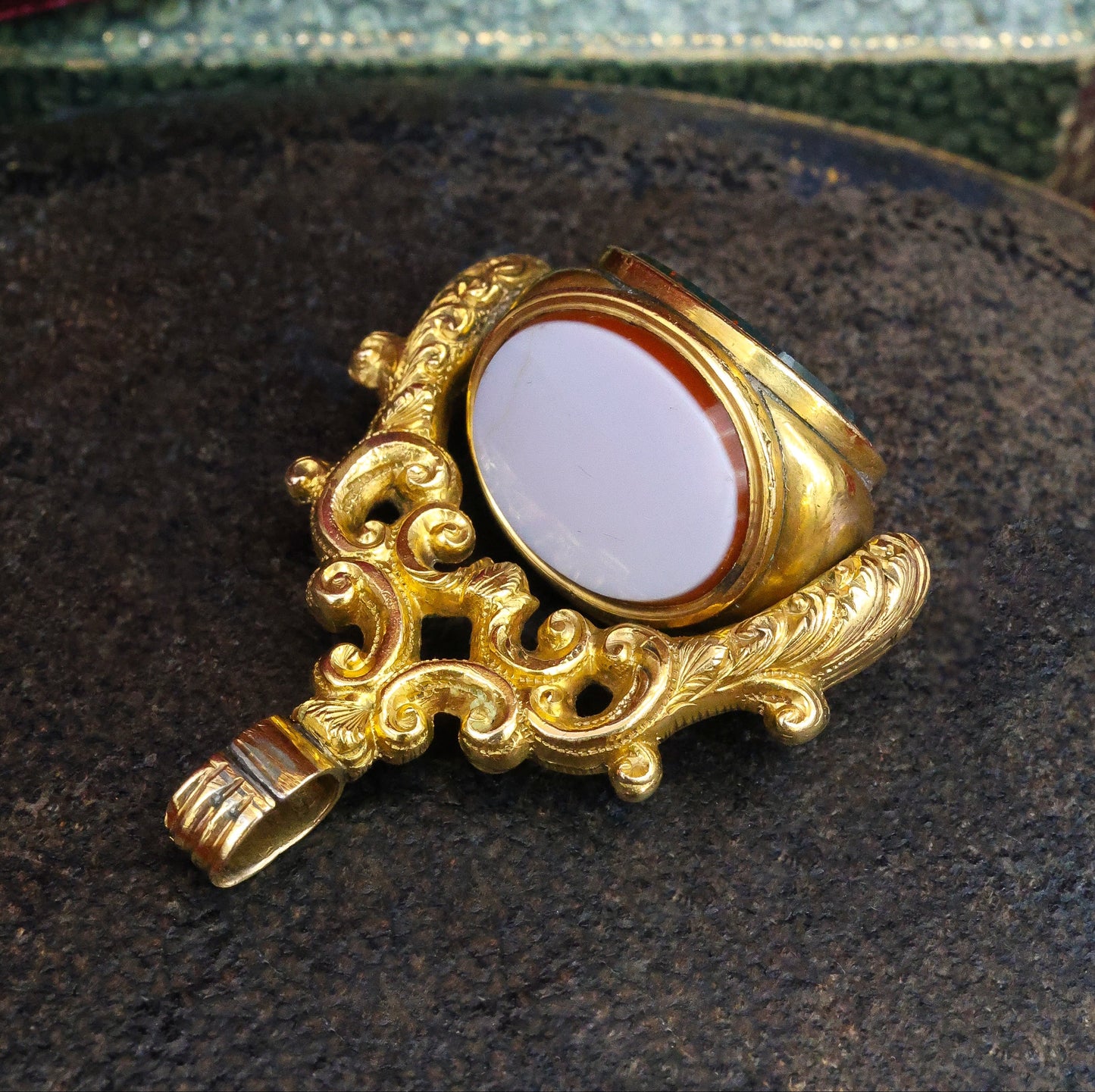 A late Georgian Pinchbeck, revolving, triple Seal, set with three oval (unmarked), Hardstones: Bloodstone, Carnelian & Carnelian with Viterous Lustre.  Circa. 1820