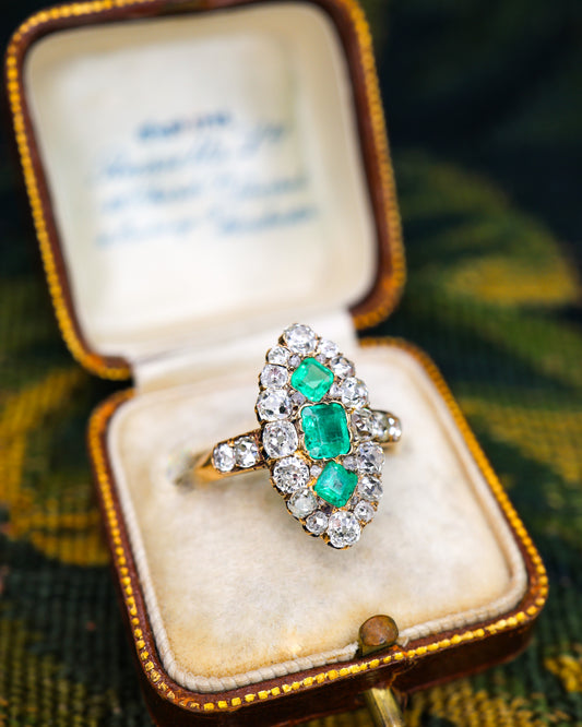 A very fine antique 18 ct. Yellow Gold (tested),  Navette shaped ring set with three Octagonal Step Cut Natural Emeralds & numerous Diamonds, with Diamond set shoulders. English. Circa 1870.