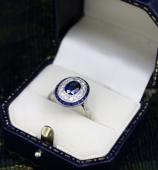 A very fine Platinum, Diamond & Sapphire Oval Target Ring, centrally Rub-over set with an Unheated Burma Sapphire. French. Circa 1930. - Robin Haydock Antiques