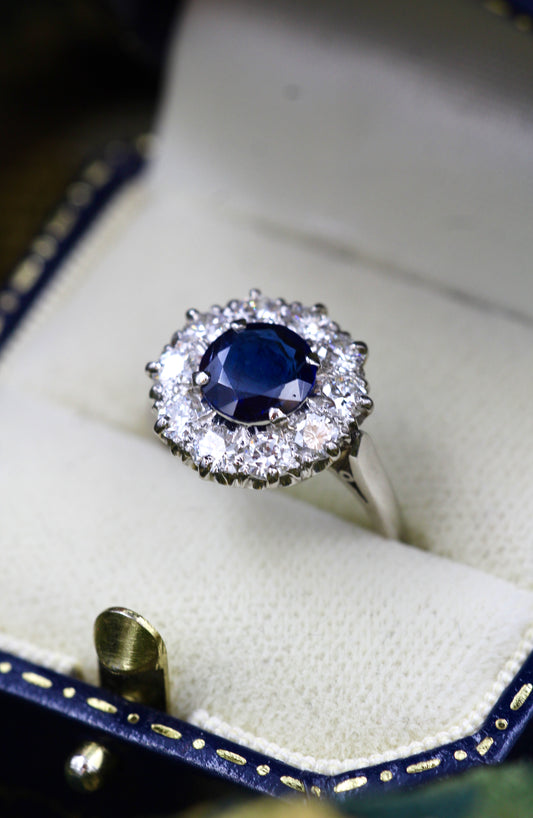 A fine Round Sapphire and Diamond Cluster Ring mounted in Platinum (tested). Mid 20th Century.