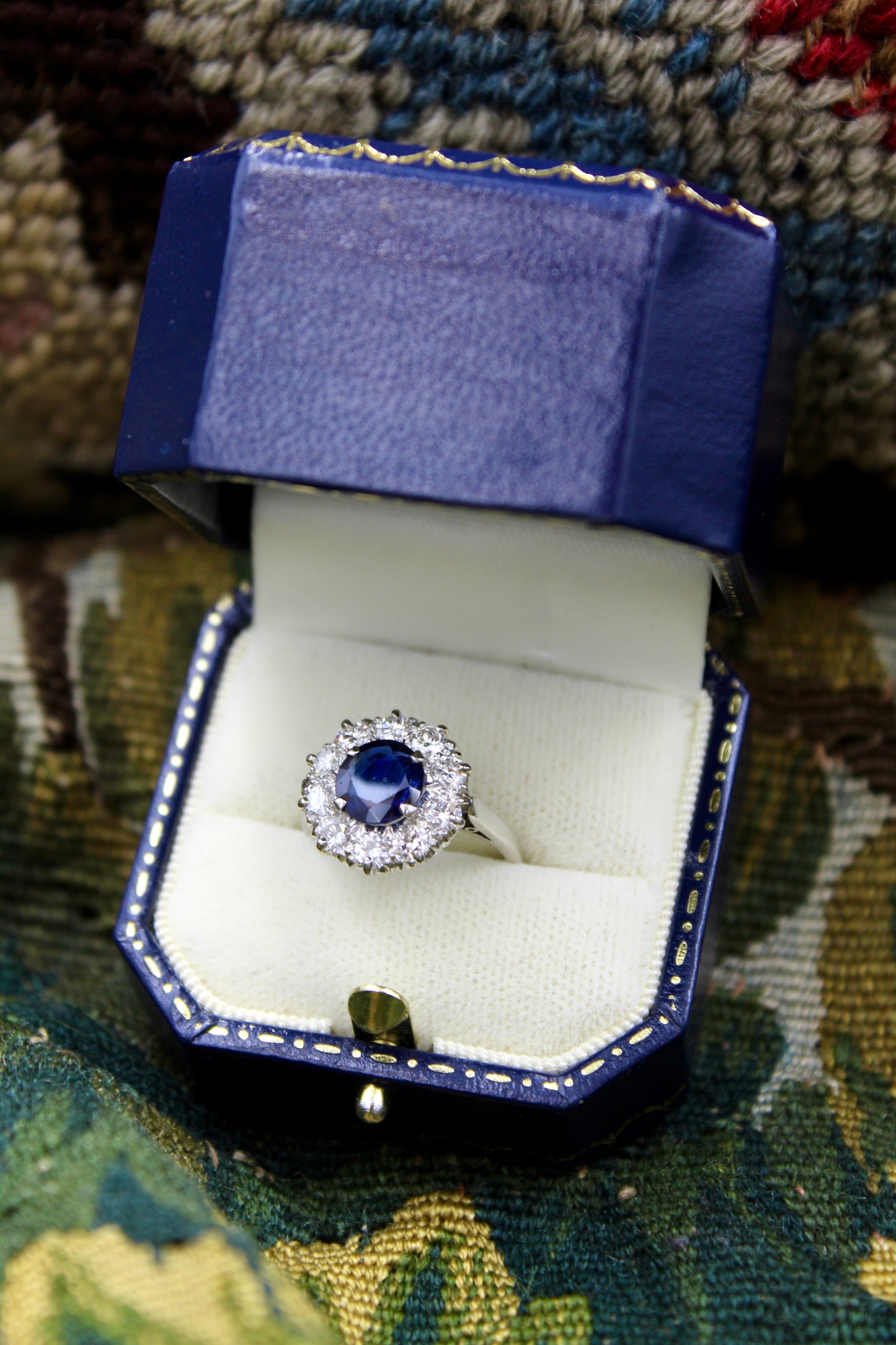 A fine Round Sapphire and Diamond Cluster Ring mounted in Platinum (tested). Mid 20th Century.