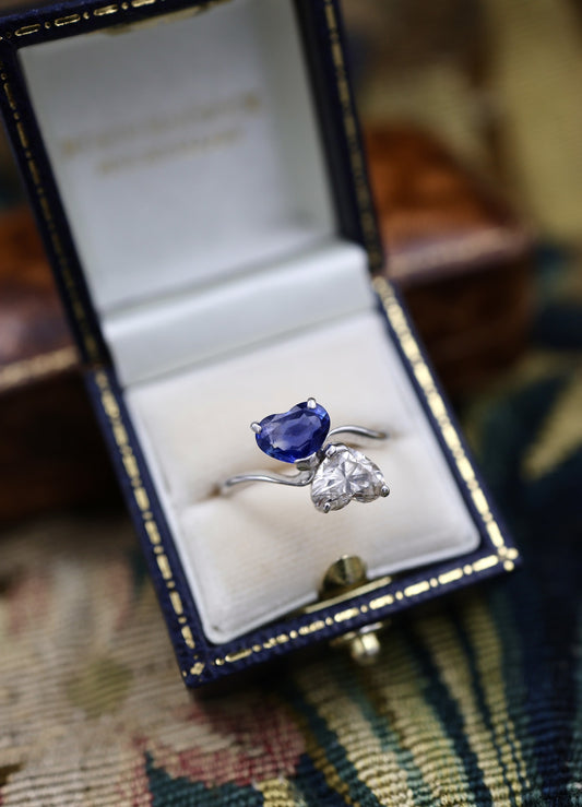 A remarkable 18ct White Gold (French import marks),  Heart Shaped Sapphire & Diamond, Moi et Toi, Two Stone Twist Ring.  Pre-owned