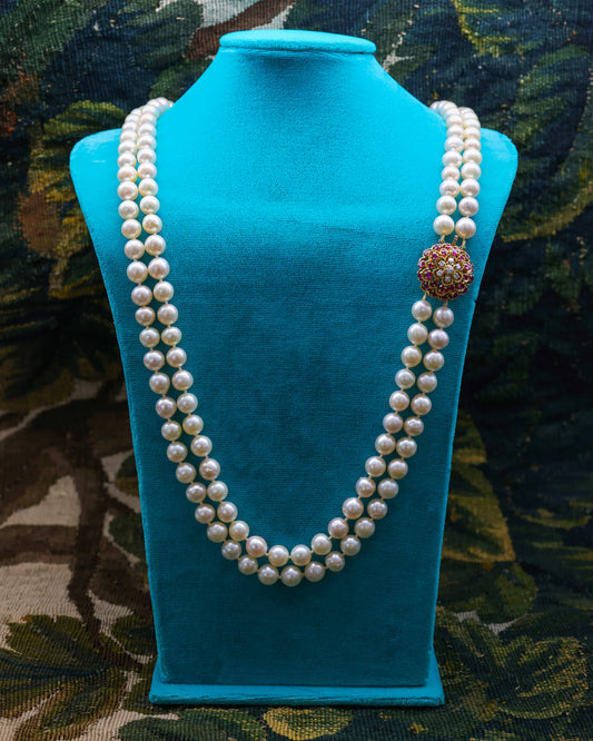 A very fine 18ct Yellow Gold  "Kutchinsky"(Signed), Double Stranded Akoya , Cultured Pearl Necklace, with a Clasp, set throughout with Burma Untreated Rubies & Diamonds. English. Circa 1950