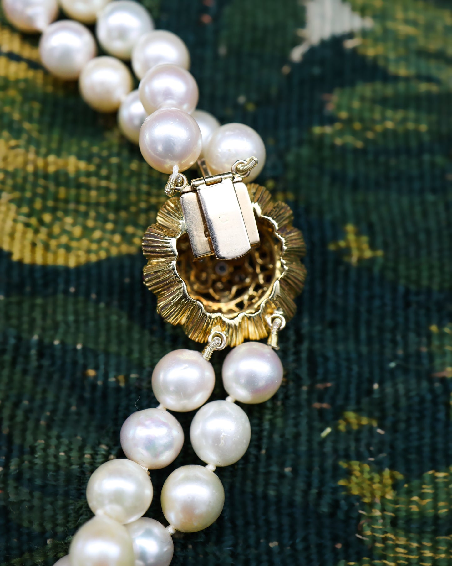 A very fine 18ct Yellow Gold  "Kutchinsky"(Signed), Double Stranded Akoya , Cultured Pearl Necklace, with a Clasp, set throughout with Burma Untreated Rubies & Diamonds. English. Circa 1950