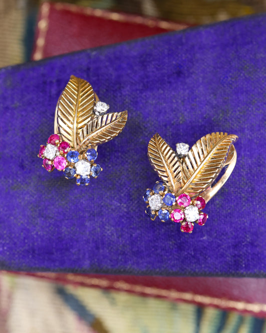 A very fine pair of 18ct Yellow & White Gold (tested), Retro, Clip Earrings,  a Stylised Foliate Design set throughout with Diamonds, Burma Rubies & Sapphires. Circa 1940