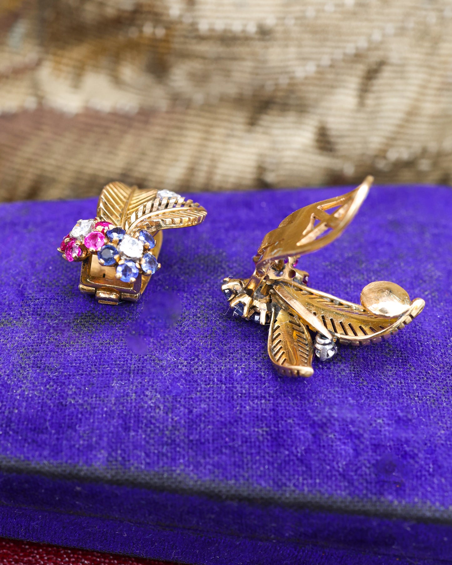 A very fine pair of 18ct Yellow & White Gold (tested), Retro, Clip Earrings,  a Stylised Foliate Design set throughout with Diamonds, Burma Rubies & Sapphires. Circa 1940