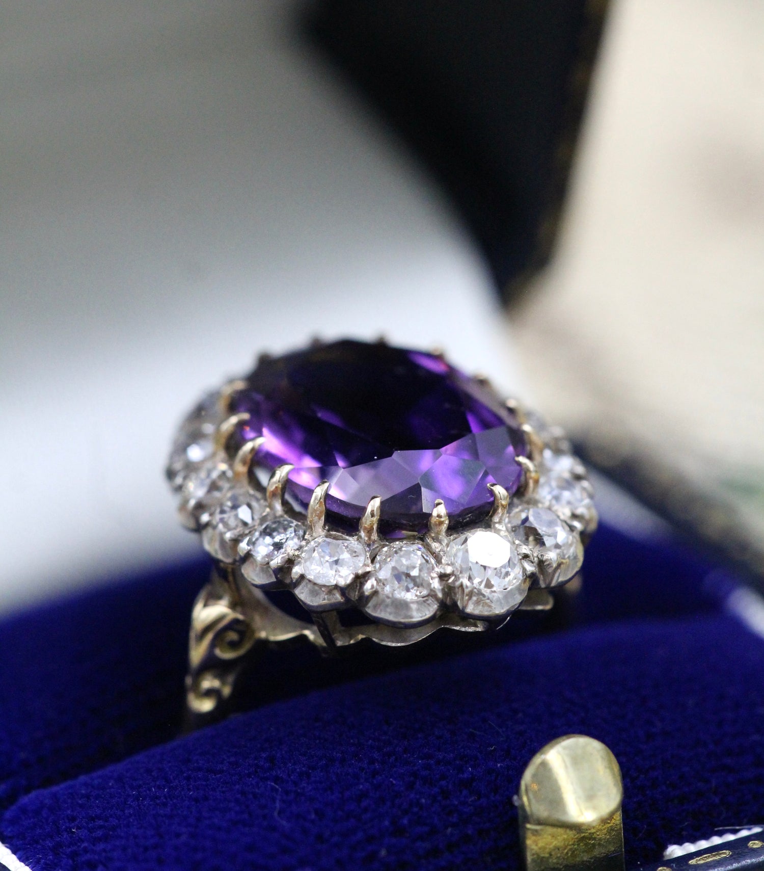 An Amethyst and Diamond Cluster Ring set with an Oval Amethyst, surrounded by 2.00 Carats of "Old Mine" Cut (Cushion), Shaped Diamonds, mounted in Silver on Gold, stamped 18 ct. Circa 1900. - Robin Haydock Antiques