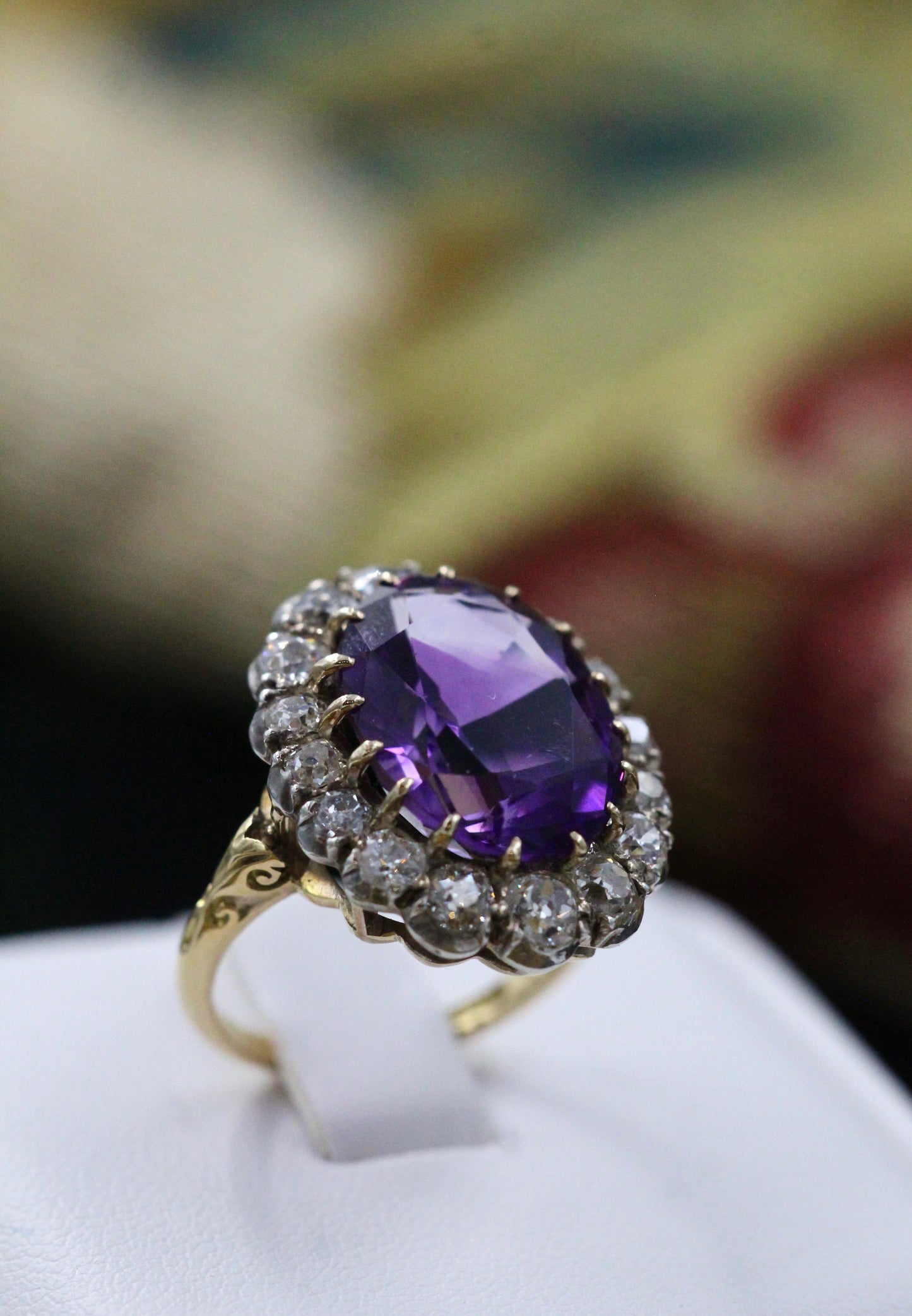 An Amethyst and Diamond Cluster Ring set with an Oval Amethyst, surrounded by 2.00 Carats of "Old Mine" Cut (Cushion), Shaped Diamonds, mounted in Silver on Gold, stamped 18 ct. Circa 1900. - Robin Haydock Antiques