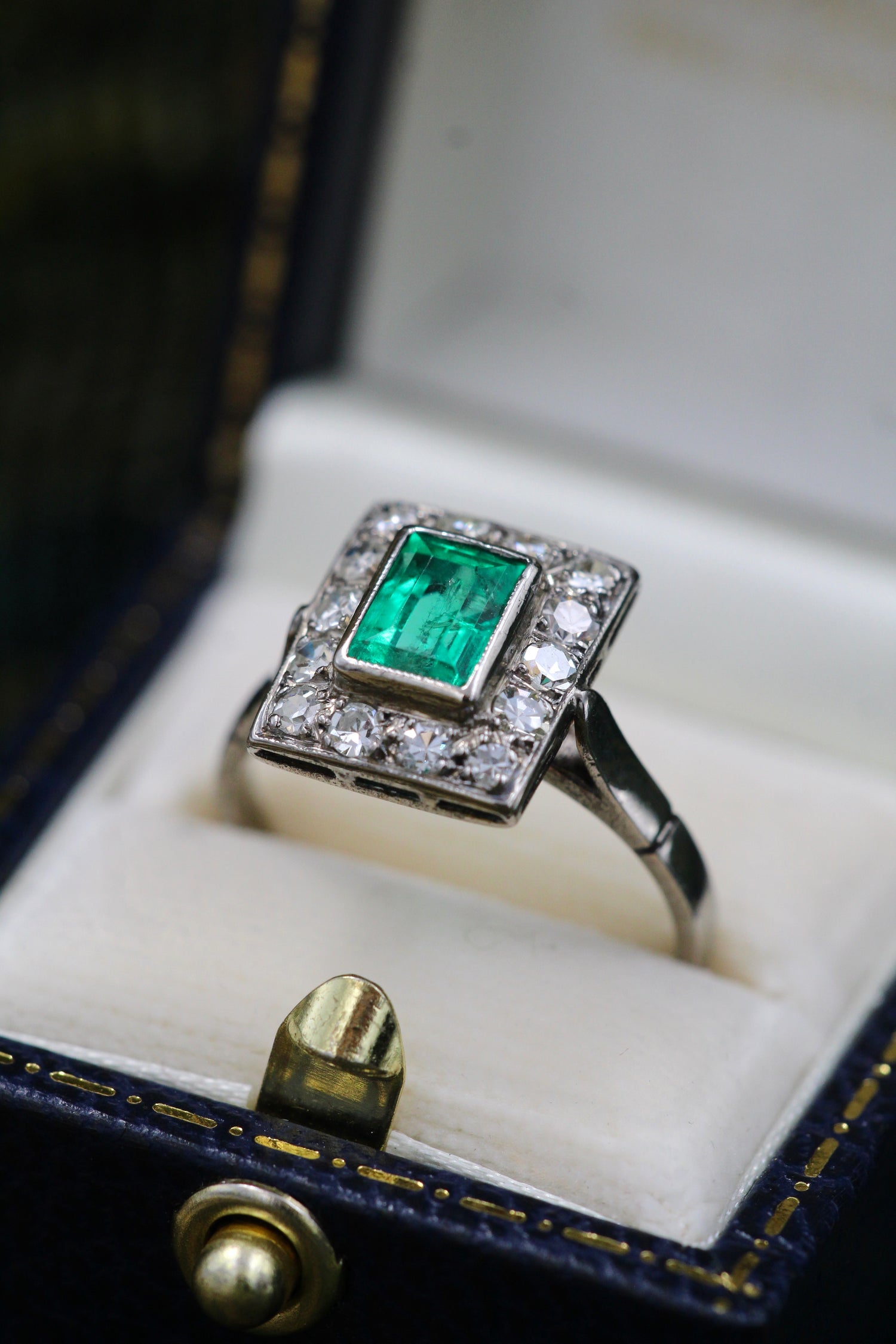A very fine Platinum (tested) Cluster Ring set with a Modified Step Cut Emerald Certified as 1.10 carats "Colombian" (Moderate Oil), surrounded by gallery of fourteen Single Cut Diamonds. Circa 1930 - Robin Haydock Antiques