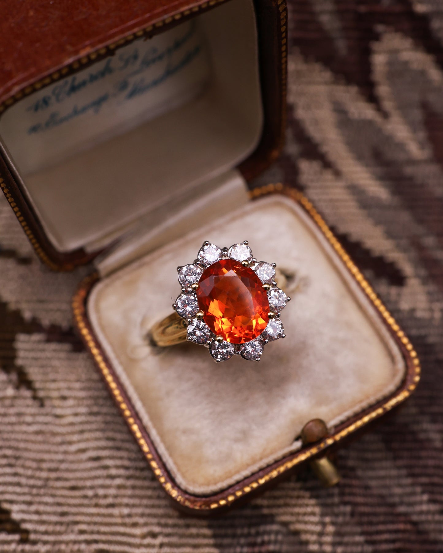 A very fine 18 Carat Yellow & White Gold Oval Fire Opal and Diamond Cluster Ring. London Hallmarks. Circa 1993.