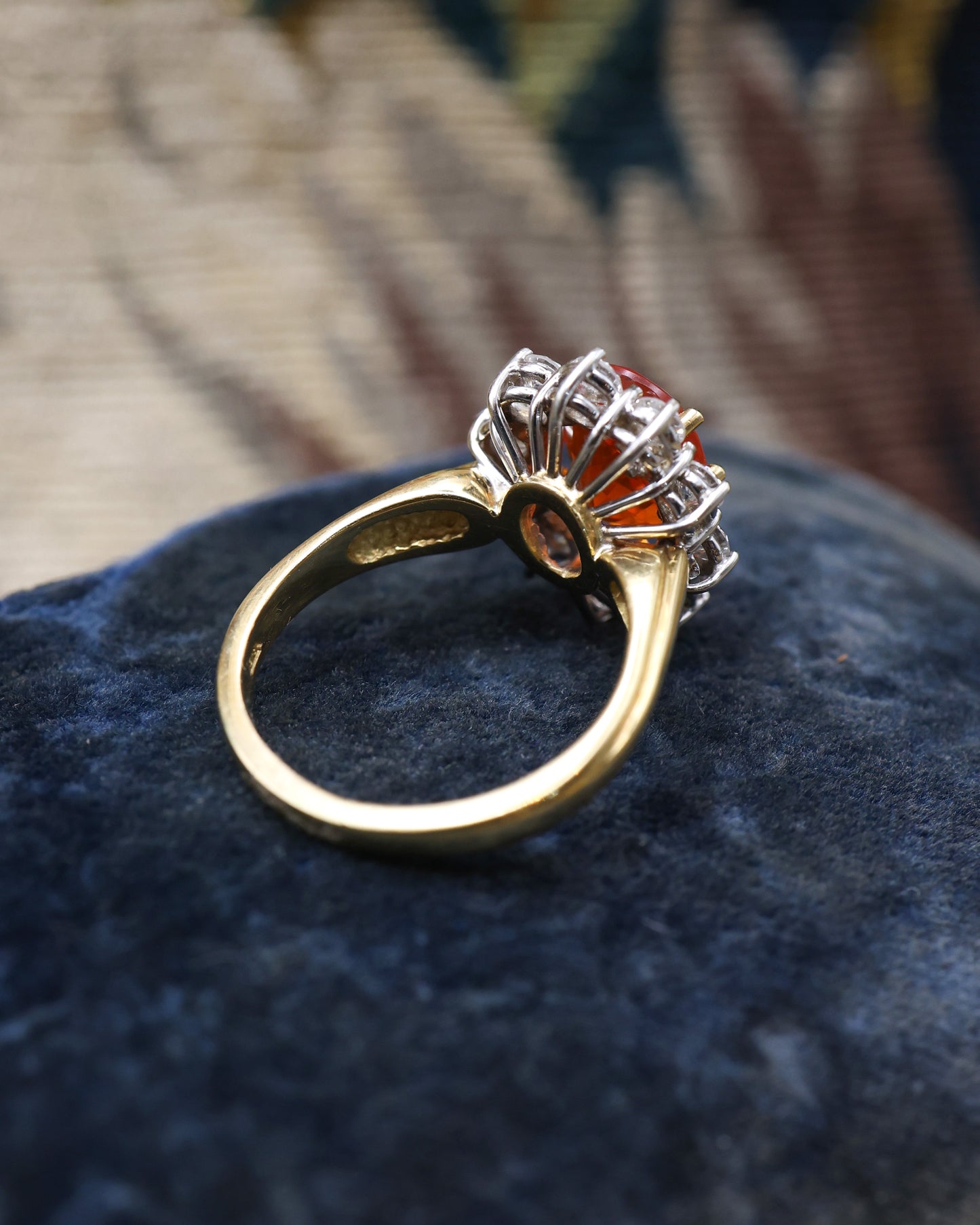 A very fine 18 Carat Yellow & White Gold Oval Fire Opal and Diamond Cluster Ring. London Hallmarks. Circa 1993.