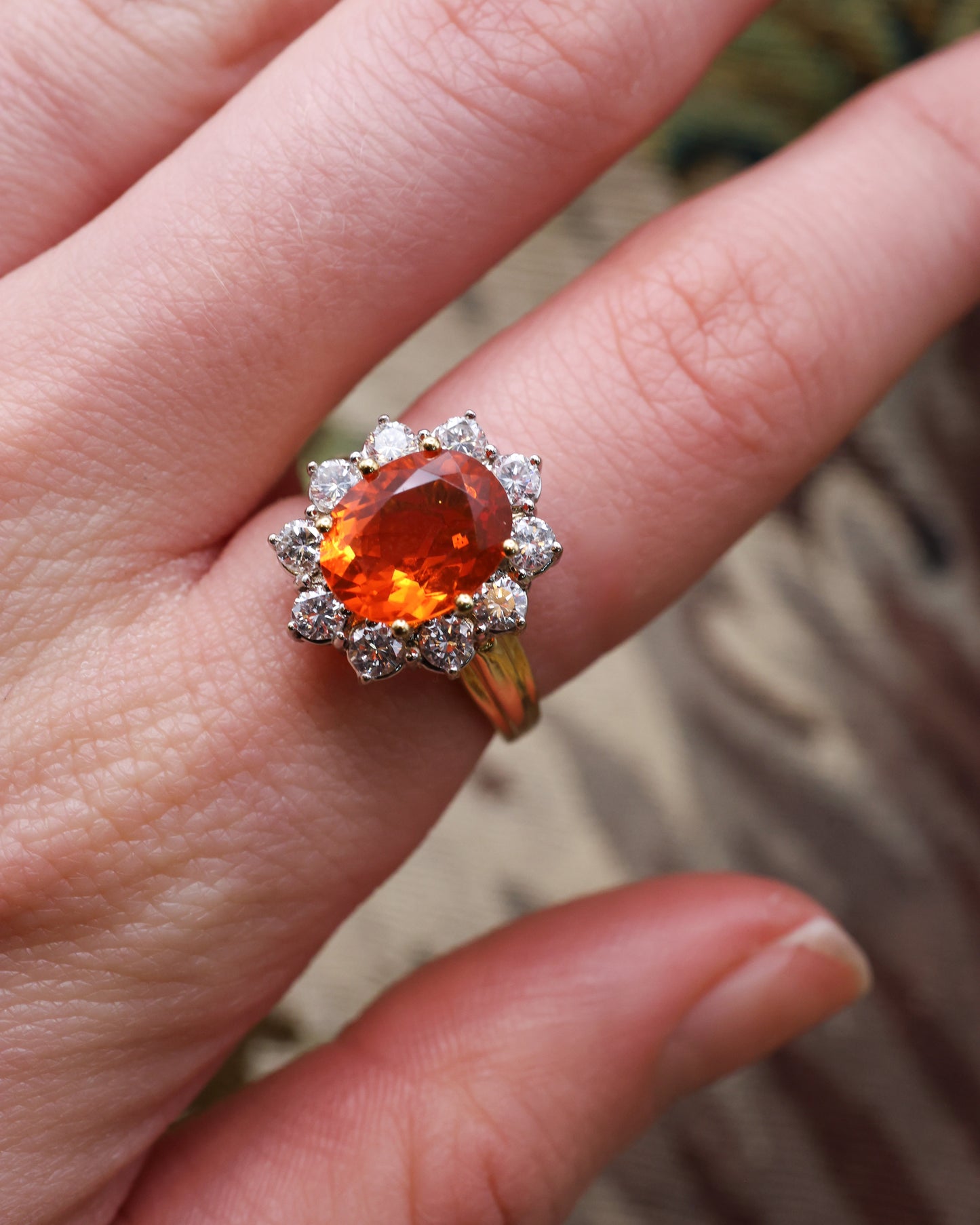 A very fine 18 Carat Yellow & White Gold Oval Fire Opal and Diamond Cluster Ring. London Hallmarks. Circa 1993.