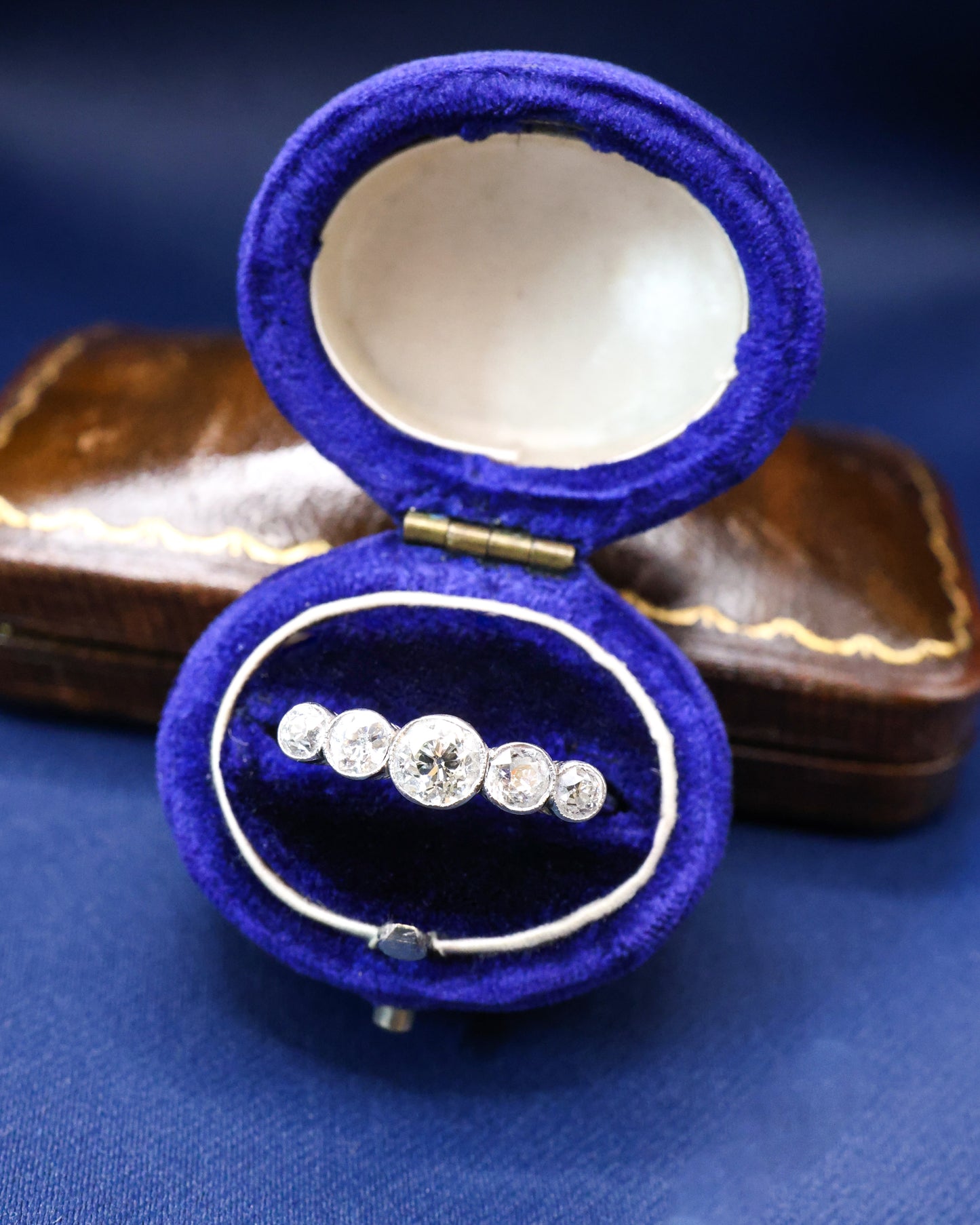 A very fine 18ct. White Gold (later rhodium plated), graduating five stone Diamond Ring, rub-over and granulated set with five Old European Cut, Natural Diamonds. Circa 1930