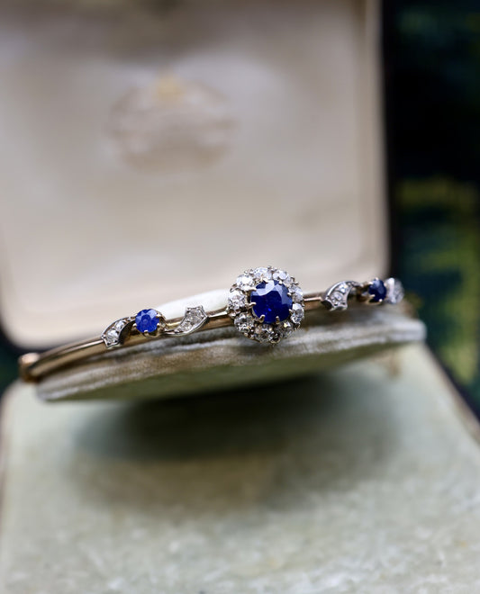 A very beautiful 15 Carat Yellow Gold (tested) Sapphire & Diamond half hinged and "knife edged style" Bangle, English, Circa 1890.