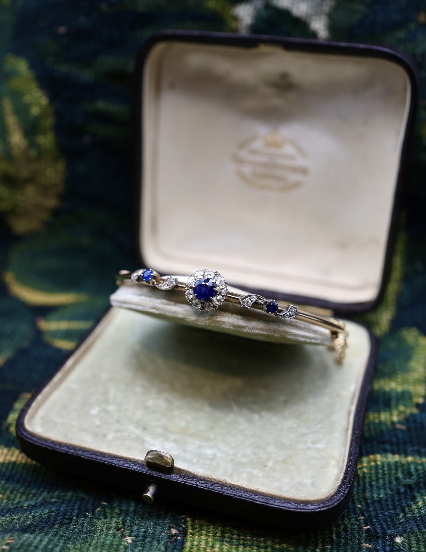 A very beautiful 15 Carat Yellow Gold (tested) Sapphire & Diamond half hinged and "knife edged style" Bangle, English, Circa 1890.