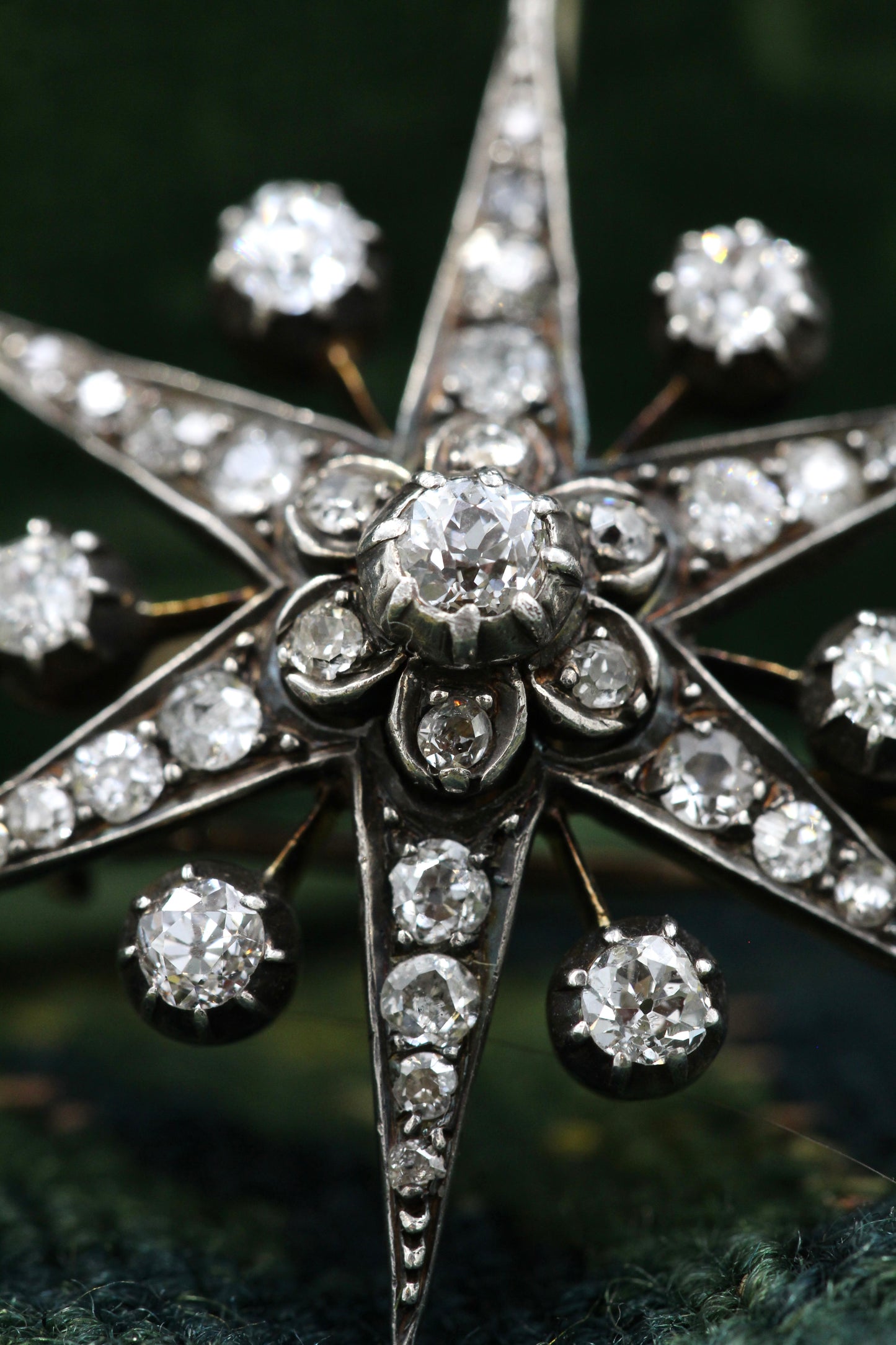 A very fine Antique High Carat Yellow Gold & Silver 6 pointed Diamond Starburst Pendant / Brooch.  Engish. Circa 1880.