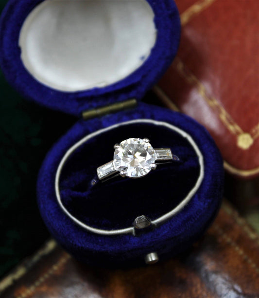 A 1.30ct Diamond Solitaire Ring to Baguette Shoulders mounted in Platinum, Circa 1950 - Robin Haydock Antiques